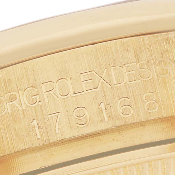 The image shows a close-up of the edge with engravings on a Rolex President 179168 Women's Yellow Gold Champagne Dial 179168 Women's Yellow Gold Champagne Dial watch.
