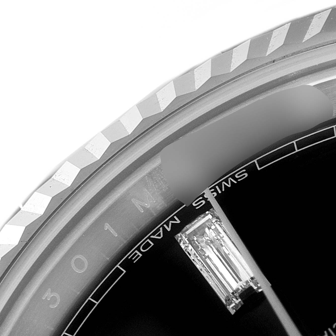 This close-up image shows the bezel and part of the dial of a Rolex President 228239 Men's White Gold Black Dial 228239 Men's White Gold Black Dial model watch.