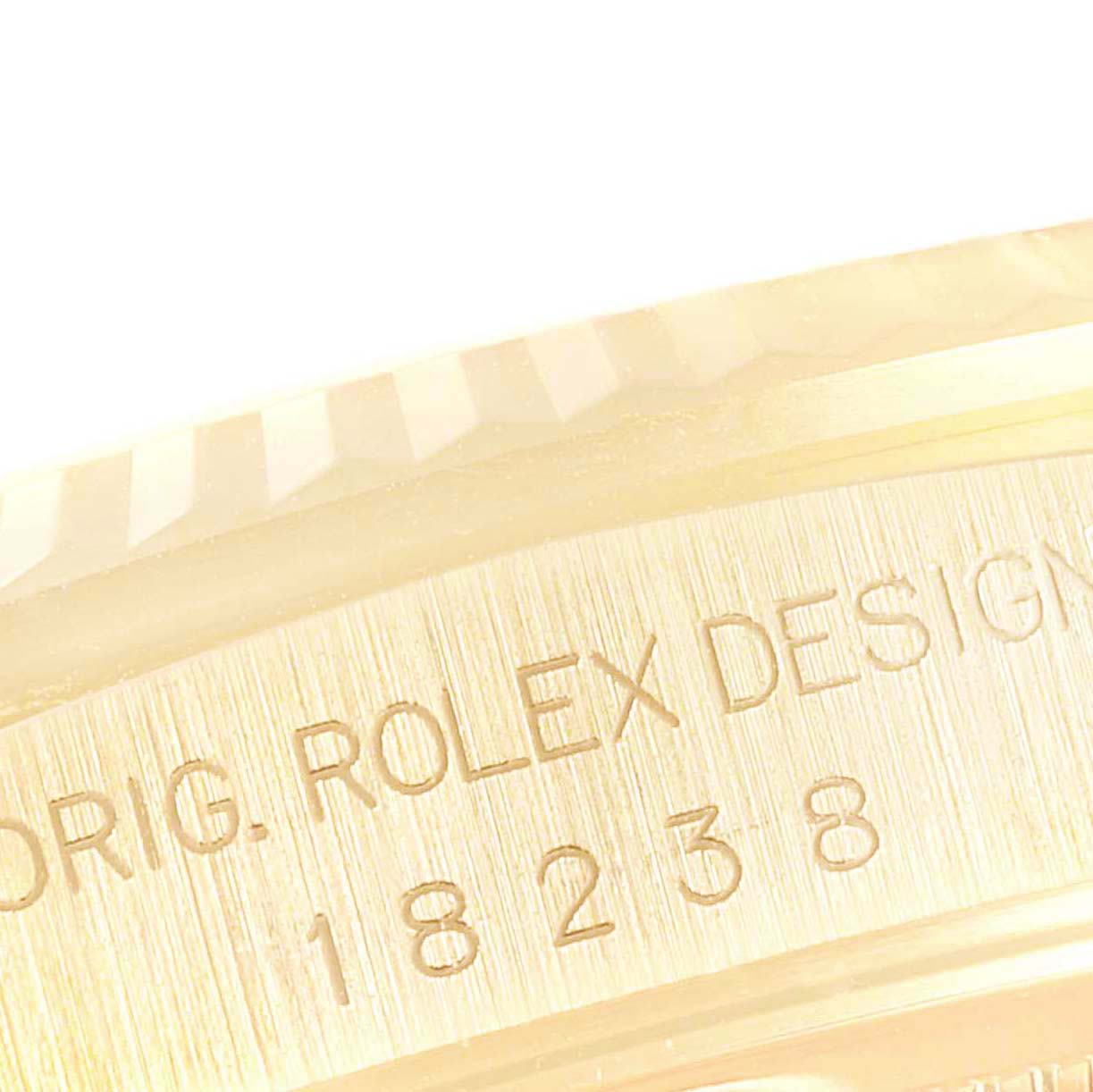 Close-up of the Rolex President 18238 Men's Yellow Gold Champagne Dial 18238 Men's Yellow Gold Champagne Dial model, focusing on the engraved part of the watch case.