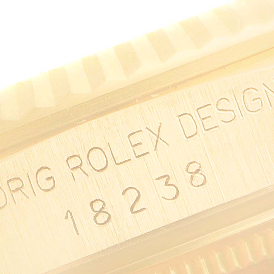 This image shows a close-up of the engraved side of a Rolex President 18238 Men's Yellow Gold Champagne Dial 18238 Men's Yellow Gold Champagne Dial model watch, revealing "ORIGINAL ROLEX DESIGN 18238."