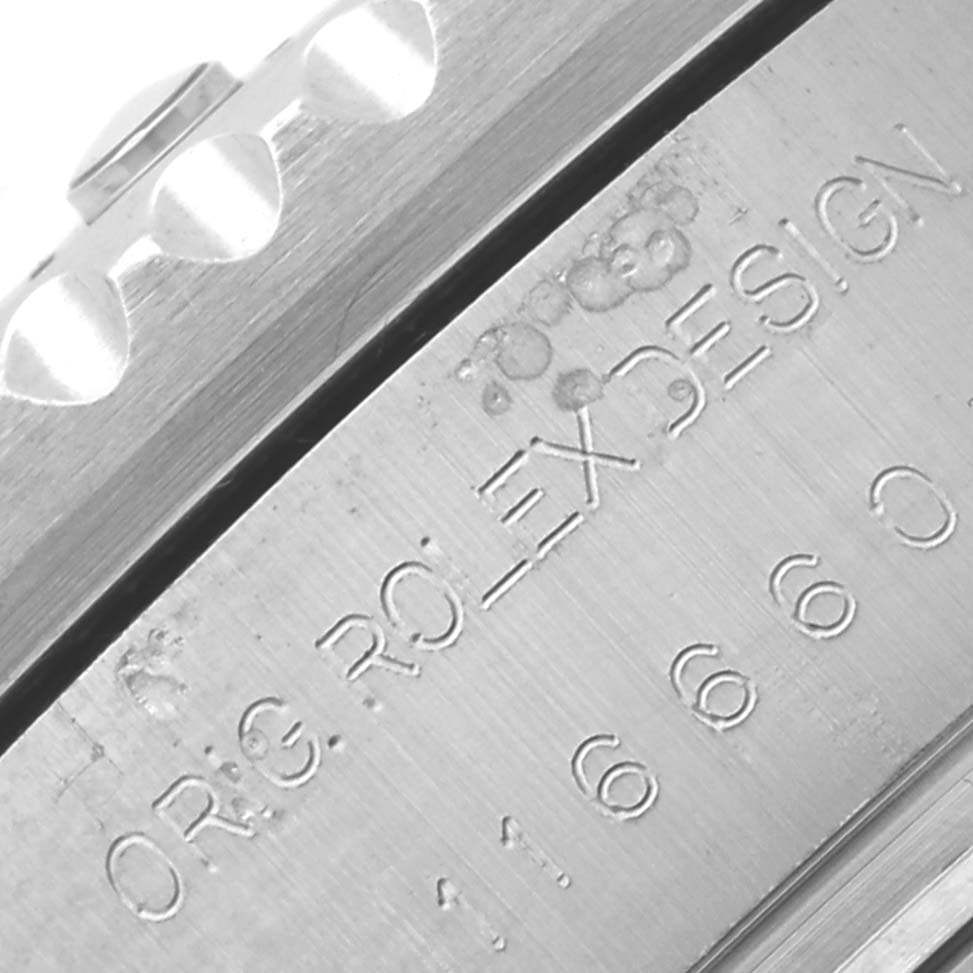 The image shows a close-up of the side engraving on the bezel of a Rolex Sea-Dweller 116660 Men's Stainless Steel Black Dial 116660 Men's Stainless Steel Black Dial watch.