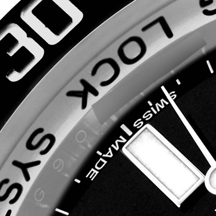 The image shows a close-up of the bezel and part of the dial of a Rolex Sea-Dweller 116660 Men's Stainless Steel Black Dial 116660 Men's Stainless Steel Black Dial watch, highlighting the "LOCK" and "SWISS MADE" text.