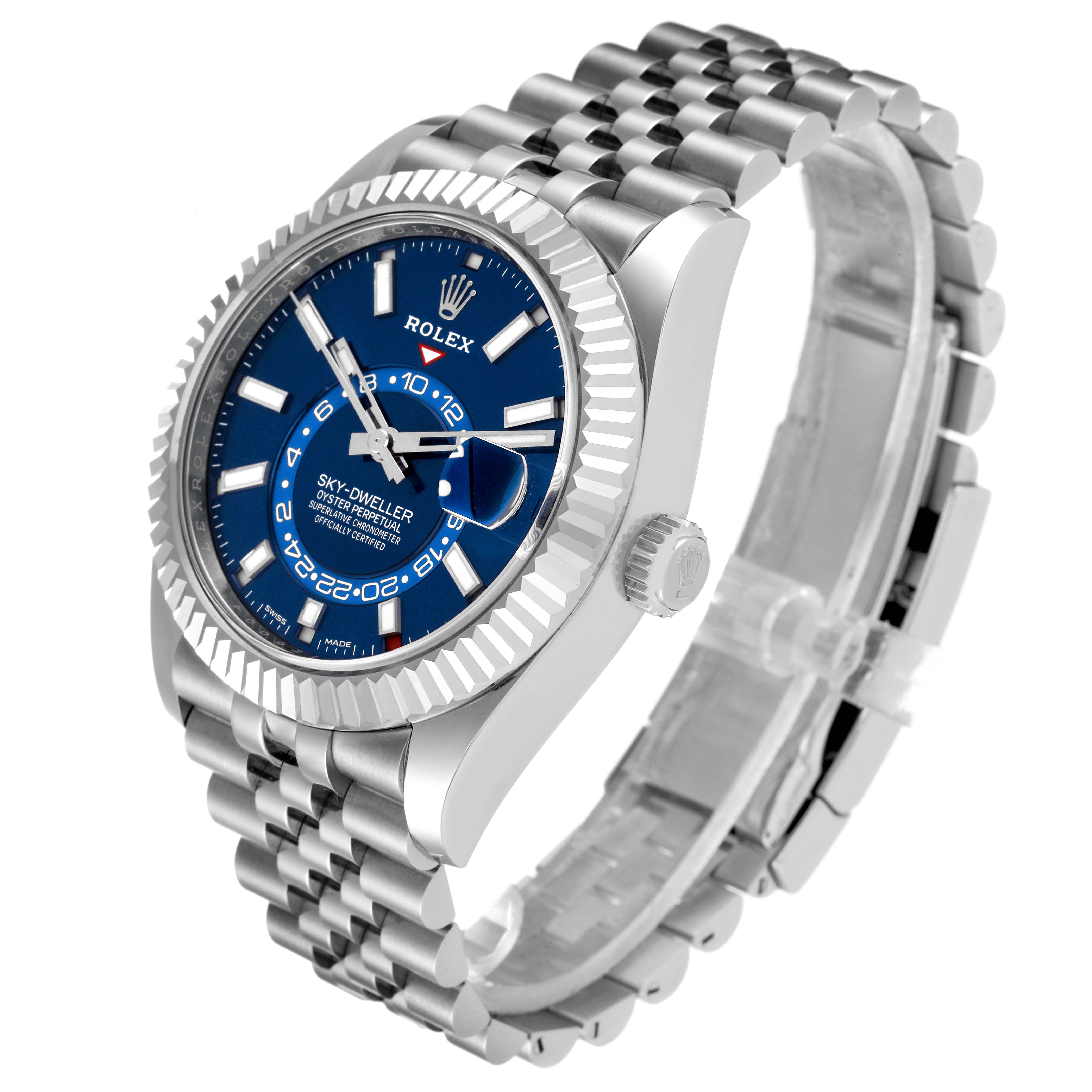 The Rolex Sky-Dweller 326934 Men's Stainless Steel Blue Dial watch is shown at a three-quarter angle, highlighting the blue dial, fluted bezel, crown, and bracelet.