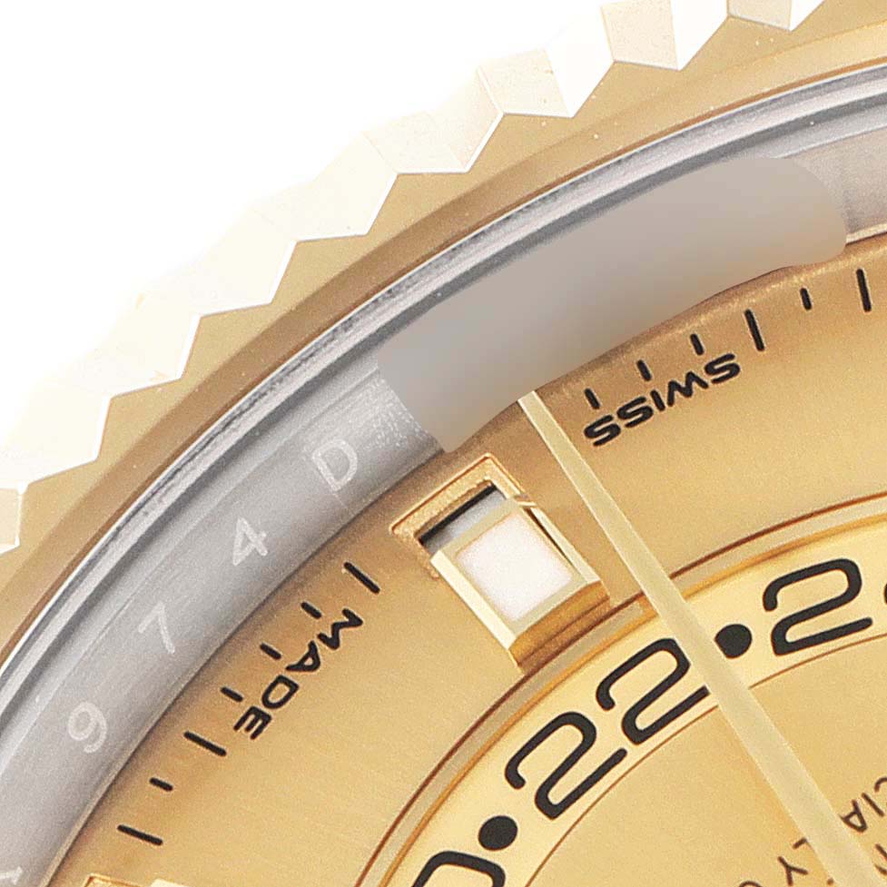 The close-up shows the bezel, part of the dial, and date indicator of the Rolex Sky-Dweller 326933 Men's Steel and Gold (two tone) Champagne Dial 326933 Men's Steel and Gold (two tone) Champagne Dial watch.