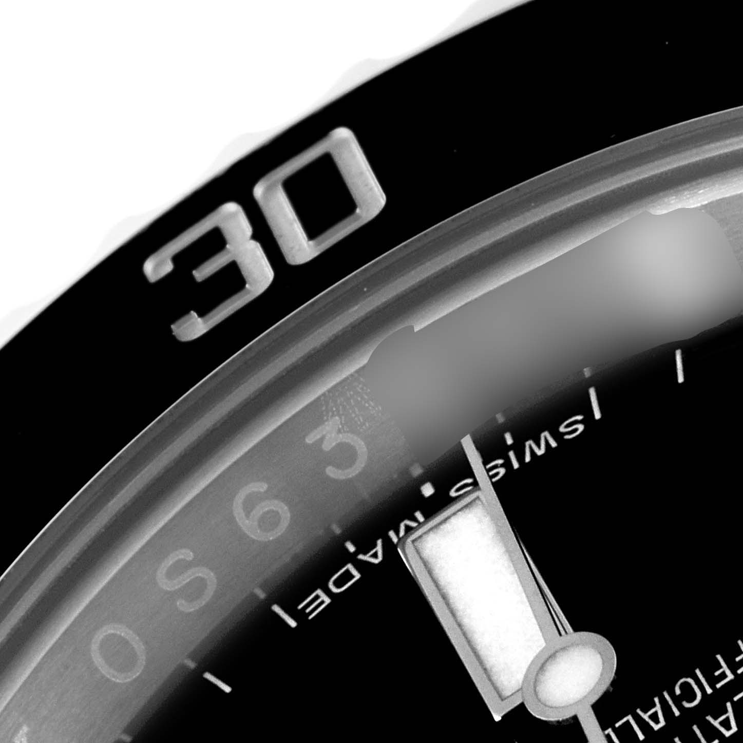 The image shows a close-up of a Rolex Submariner 114060 Men
s Stainless Steel Black Dial 114060 Men
s Stainless Steel Black Dial watch, featuring its bezel, a portion of the dial, and the minute hand.