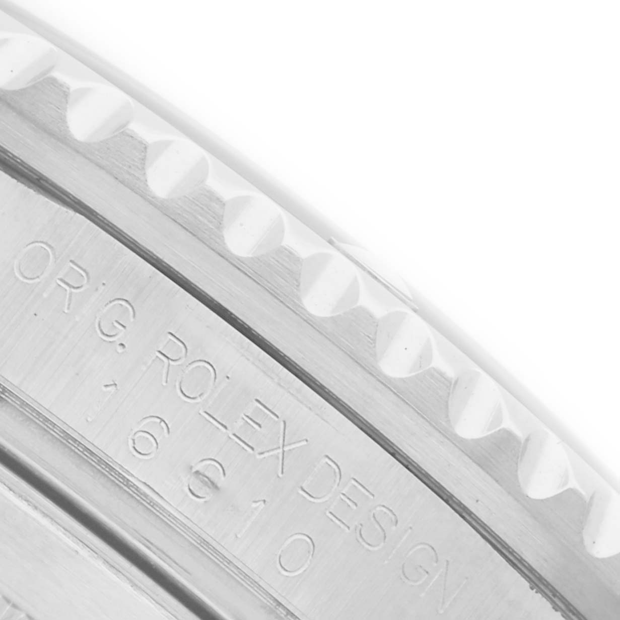 The image shows a close-up of the engraved side of a Rolex Submariner 16610 Men's Stainless Steel Black Dial 16610 Men's Stainless Steel Black Dial's bezel.