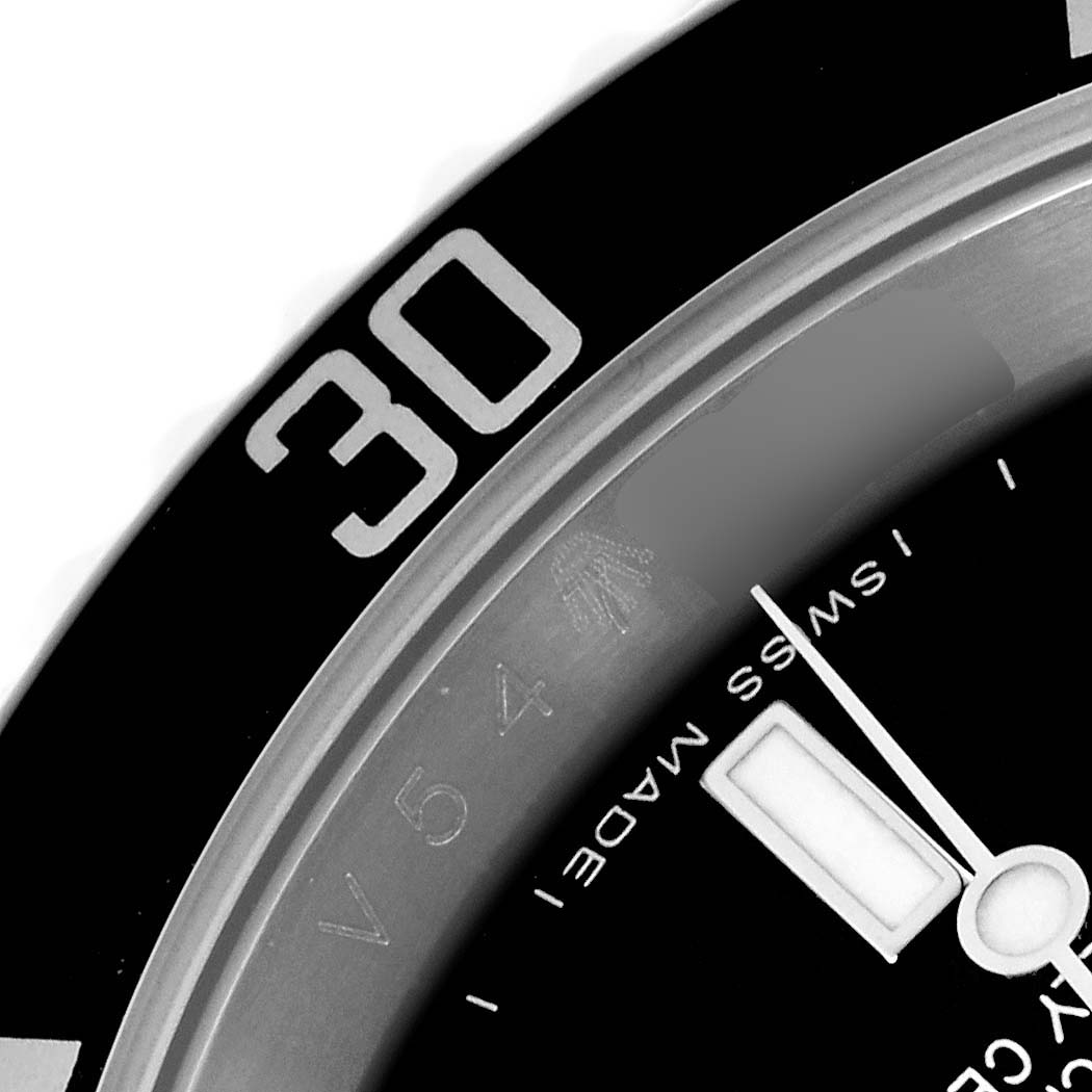 The image shows a close-up of a Rolex Submariner 16610 Men
s Stainless Steel Black Dial 16610 Men
s Stainless Steel Black Dial watch, highlighting the bezel and part of the dial with the minute hand.