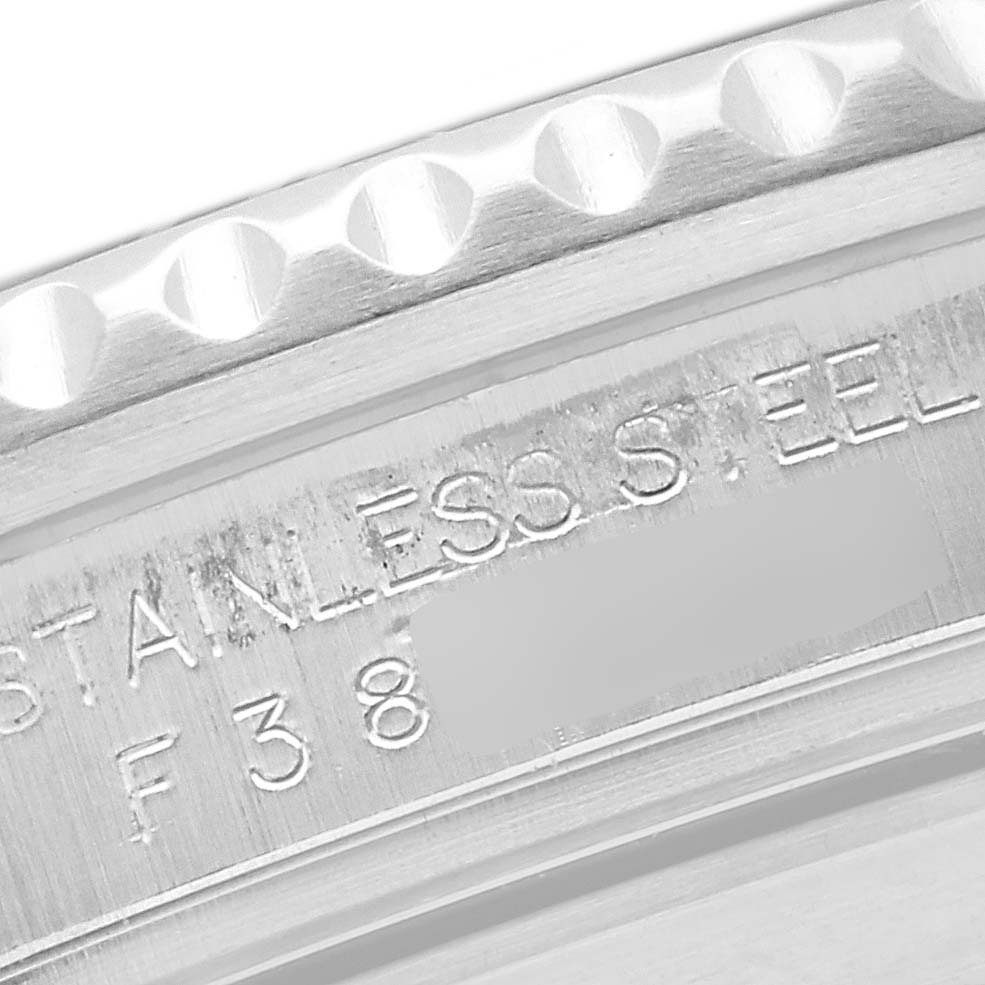 This image shows a close-up of the engraved text on the side of a Rolex Submariner 16610 Men's Stainless Steel Black Dial 16610 Men's Stainless Steel Black Dial's stainless steel casing.