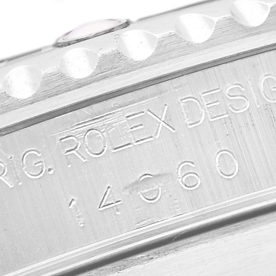 The image shows a close-up of the engraved reference number and part of the bezel on a Rolex Submariner 14060 Men's Stainless Steel Black Dial 14060 Men's Stainless Steel Black Dial watch.