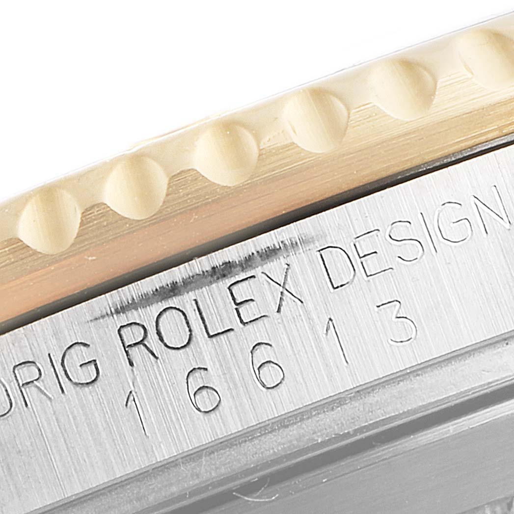 This close-up image of the Rolex Submariner 16613 Men
s Steel and Gold (two tone) Blue Dial 16613 Men
s Steel and Gold (two tone) Blue Dial shows the model number 16613 and part of the bezel and case edge.