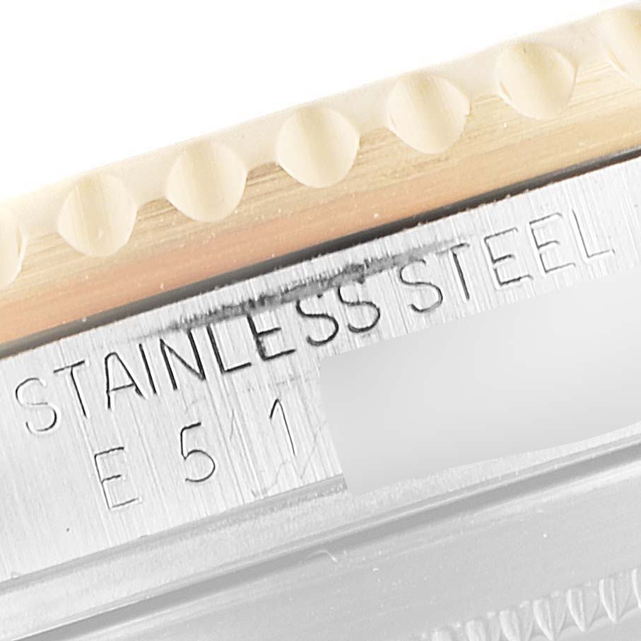 This close-up image shows the edge of the bezel and the side of the case on a Rolex Submariner 16613 Men
s Steel and Gold (two tone) Blue Dial 16613 Men
s Steel and Gold (two tone) Blue Dial watch, including the stainless steel marking.