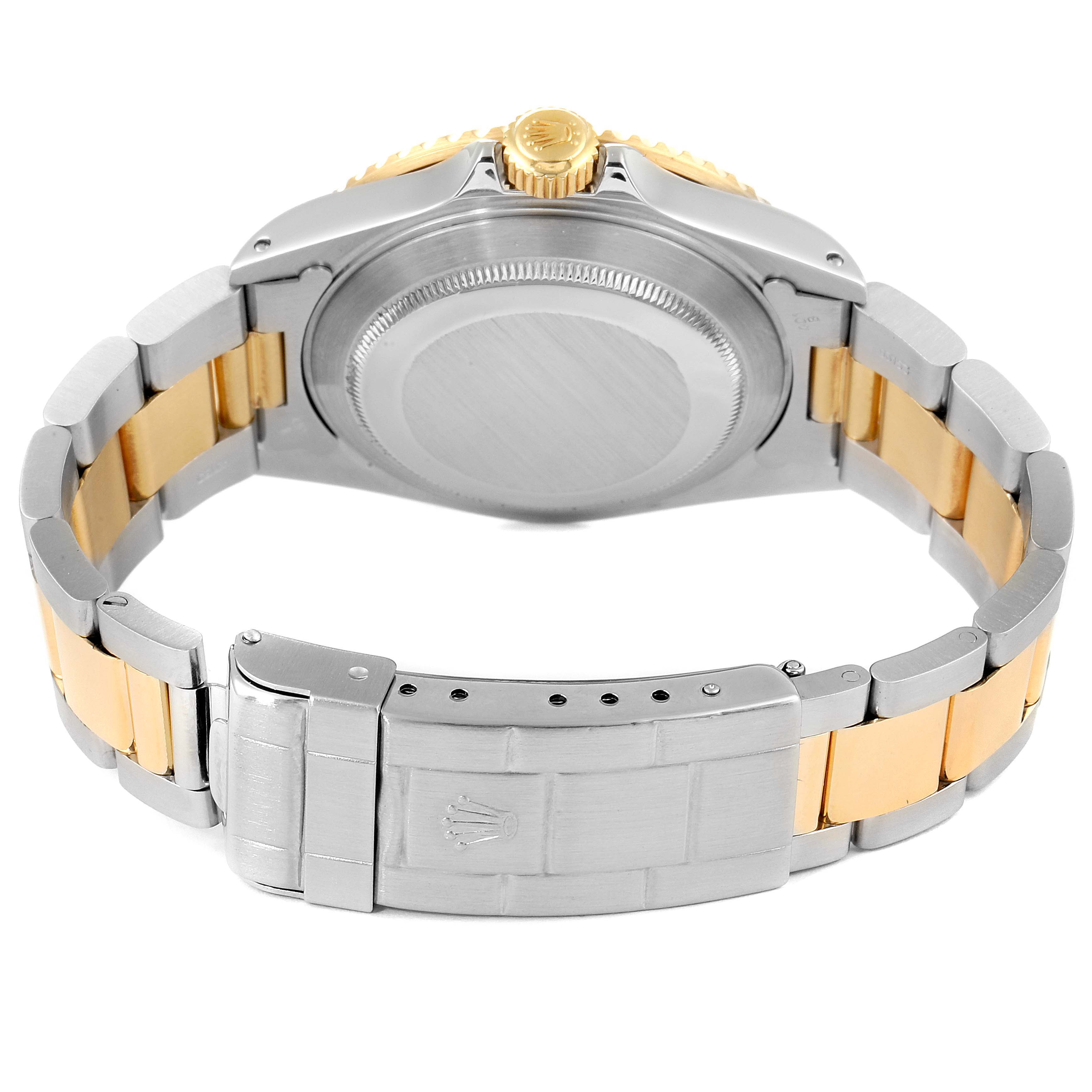 The image shows a Rolex Submariner 16613 Men
s Steel and Gold (two tone) Blue Dial 16613 Men
s Steel and Gold (two tone) Blue Dial watch from the back angle, highlighting the case back, bracelet, clasp, and crown.