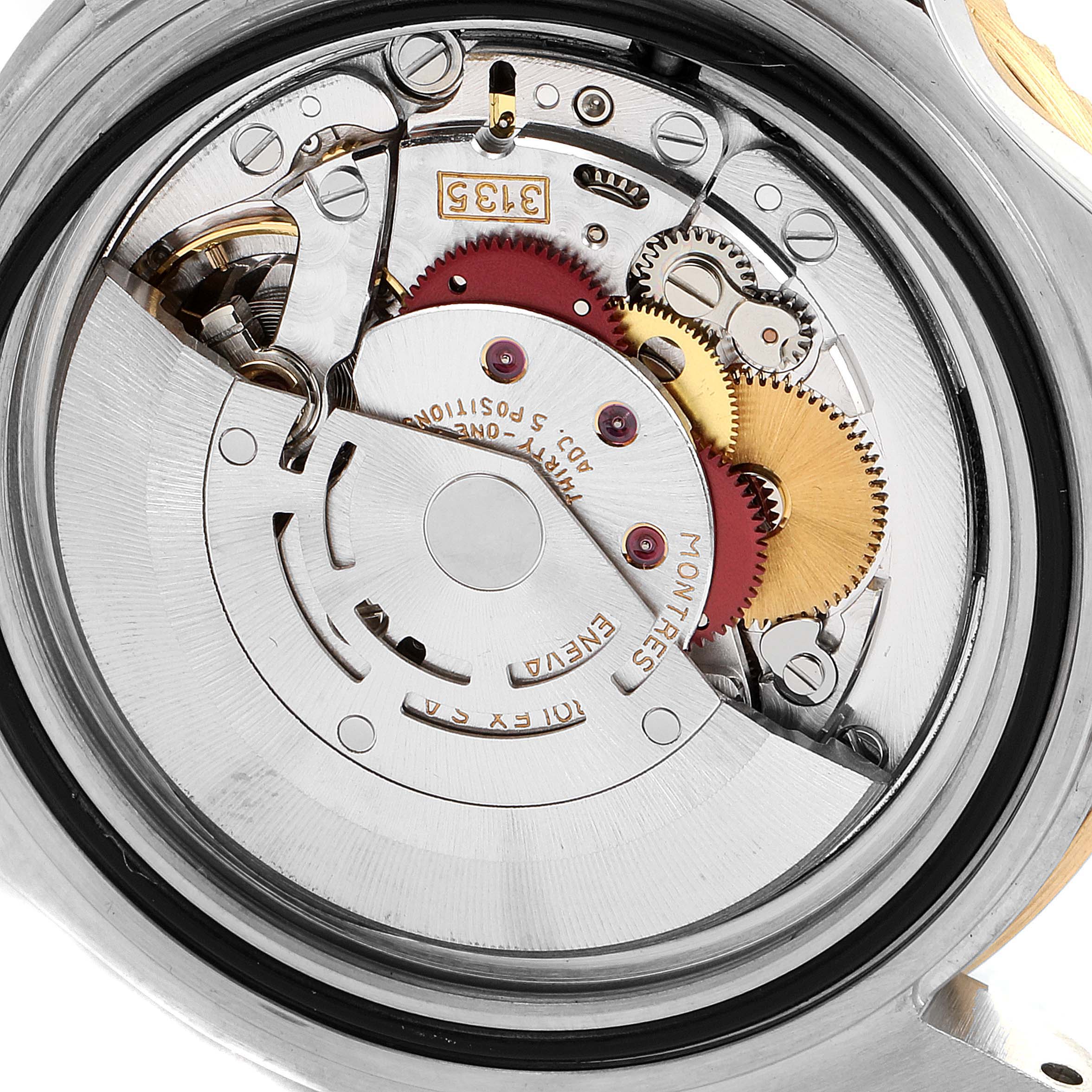 This image shows a close-up of the open case back of a Rolex Submariner 16613 Men
s Steel and Gold (two tone) Blue Dial 16613 Men
s Steel and Gold (two tone) Blue Dial watch, revealing its intricate mechanical movement.