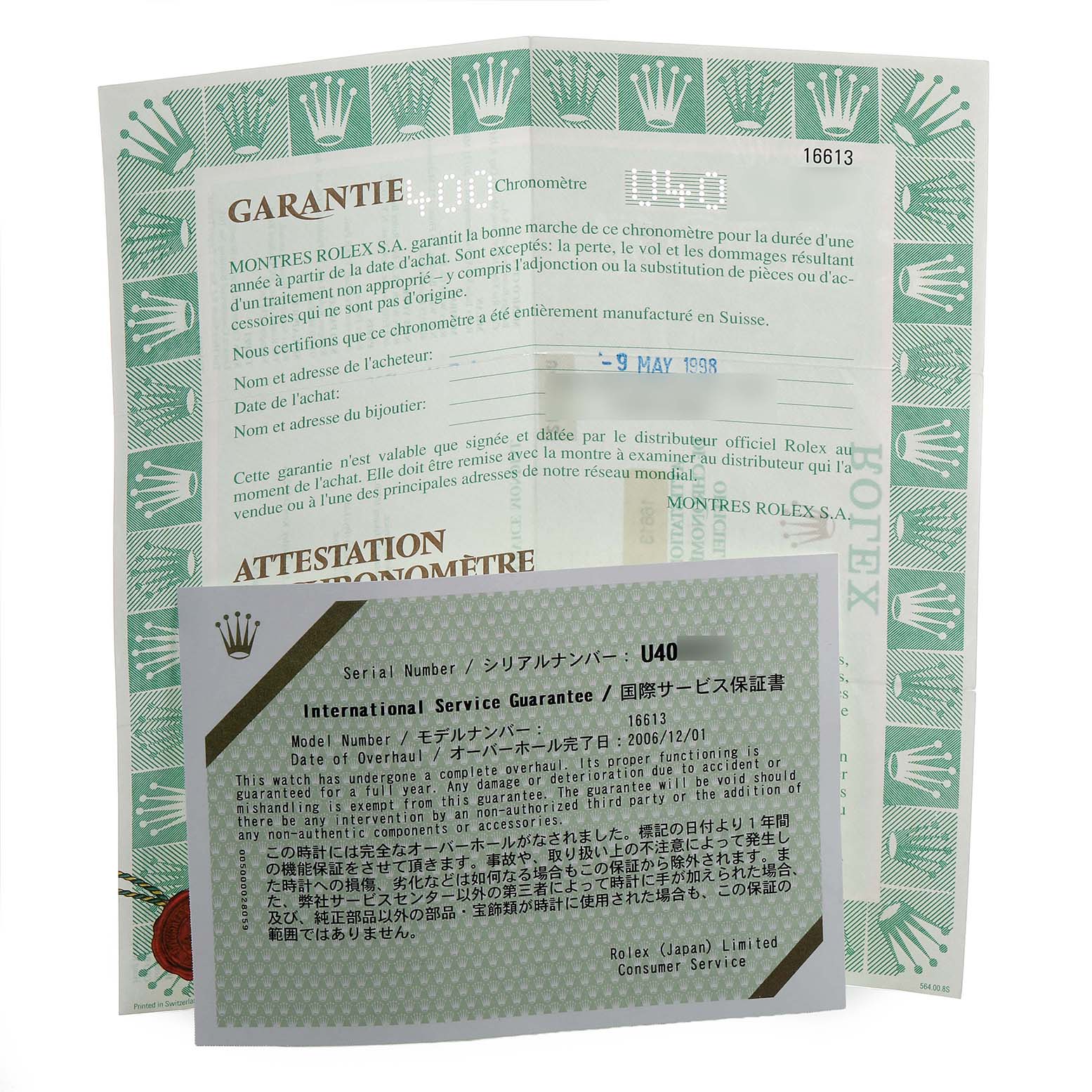 The image shows a warranty card and service guarantee documents for a Rolex Submariner 16613 Men's Steel and Gold (two tone) Blue Dial.