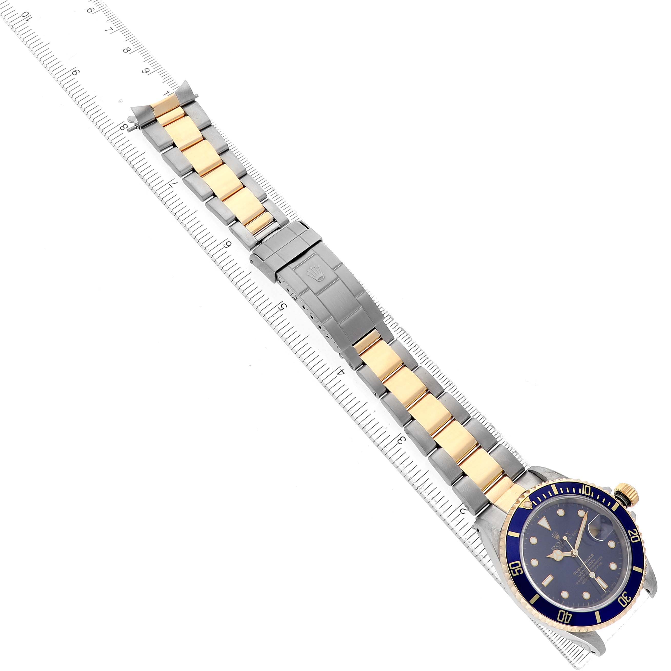 The Rolex Submariner 16613 Men's Steel and Gold (two tone) Blue Dial watch is shown from a top-down view, highlighting the blue bezel, gold and silver bracelet, and clasp.