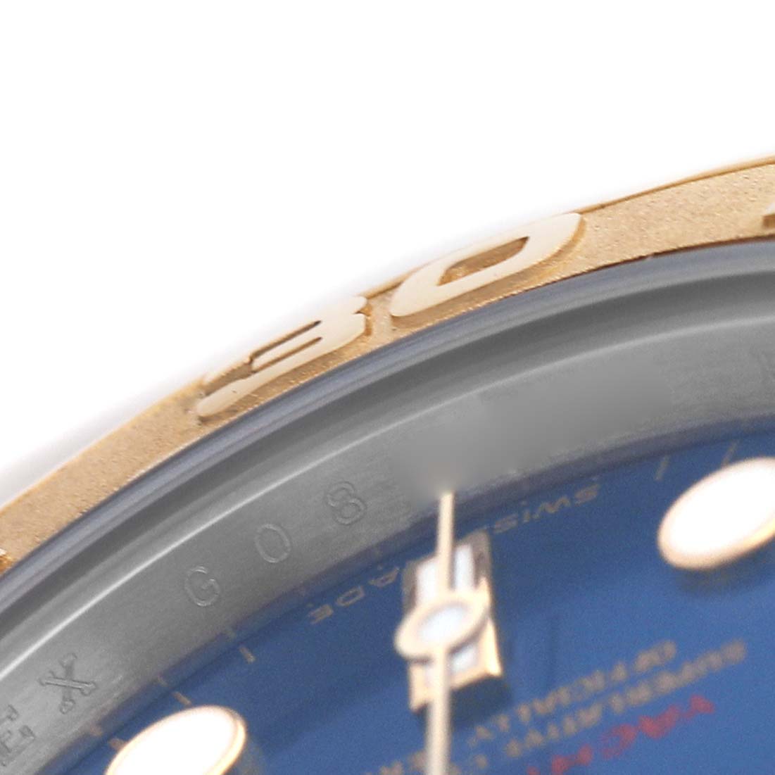 The image shows a close-up of the Rolex Yacht-Master 169623 Women's Steel and Gold (two tone) Blue Dial's bezel and part of the blue dial with hour markers.