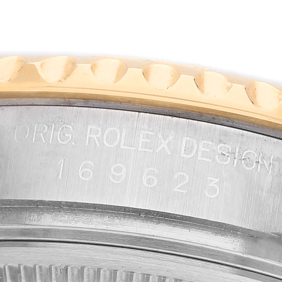 The image shows a close-up of the side of a Rolex Yacht-Master 169623 Women's Steel and Gold (two tone) Blue Dial, featuring the bezel and engraved case details.
