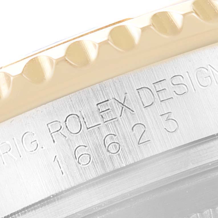 The image shows a close-up of the bezel and case side of a Rolex Yacht-Master, model 16623, highlighting the model number and engraving.