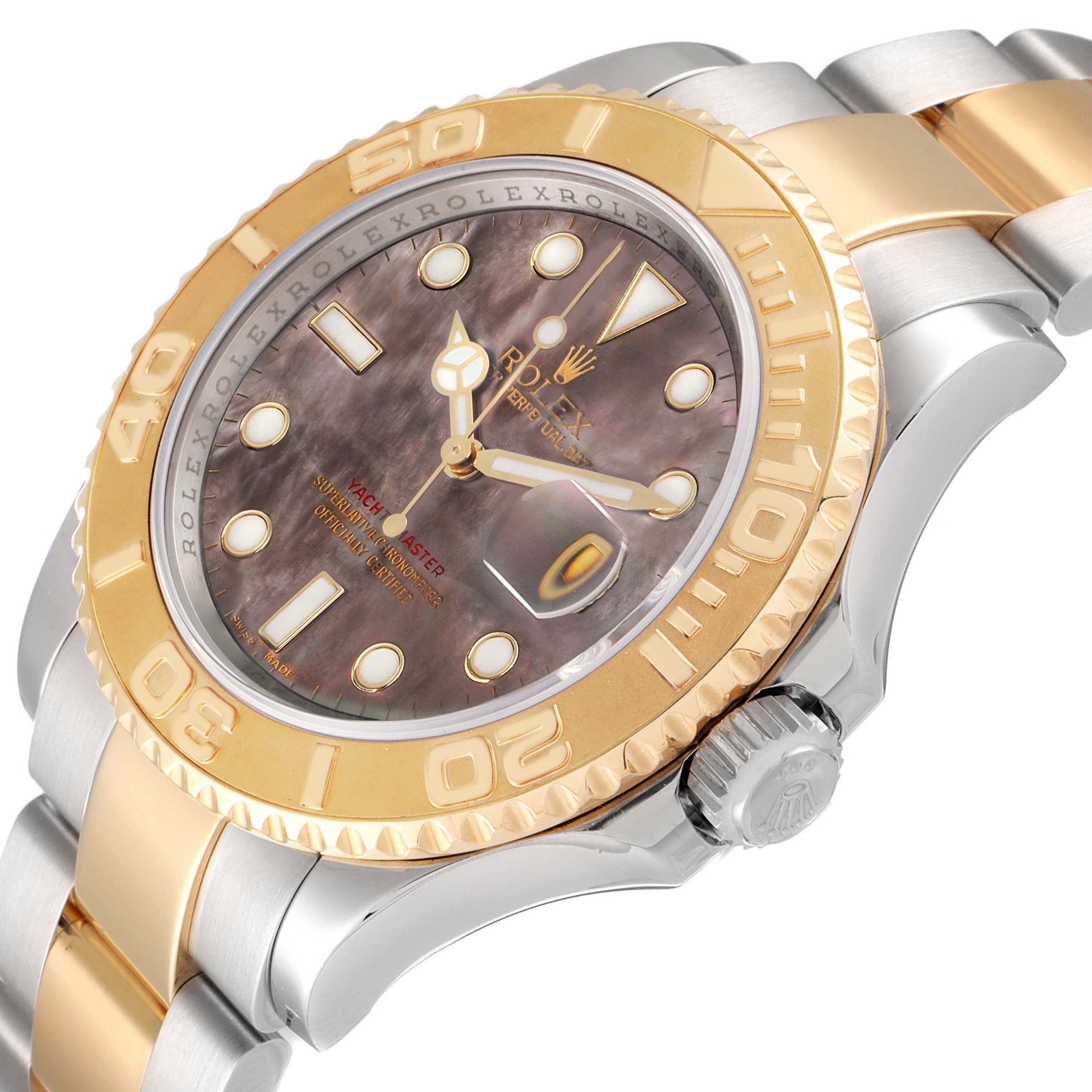 The image shows a Rolex Yacht-Master model 16623 from an angle highlighting the bezel, dial, crown, and part of the bracelet with a mix of gold and silver tones.