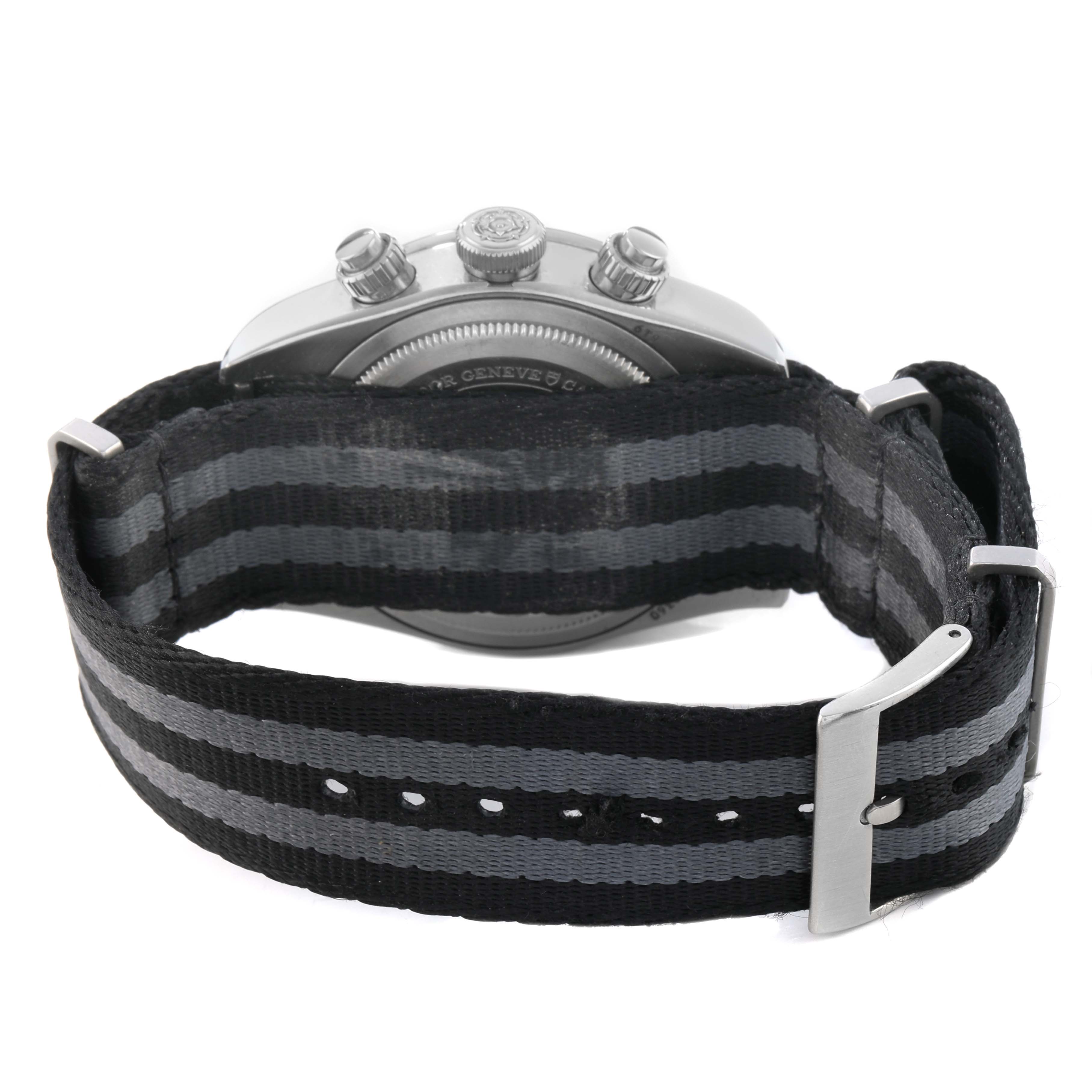 The image shows the back of a Tudor Heritage Chrono 79360 Men's Stainless Steel Silver Dial watch, highlighting its case back, crown, pushers, and NATO strap.