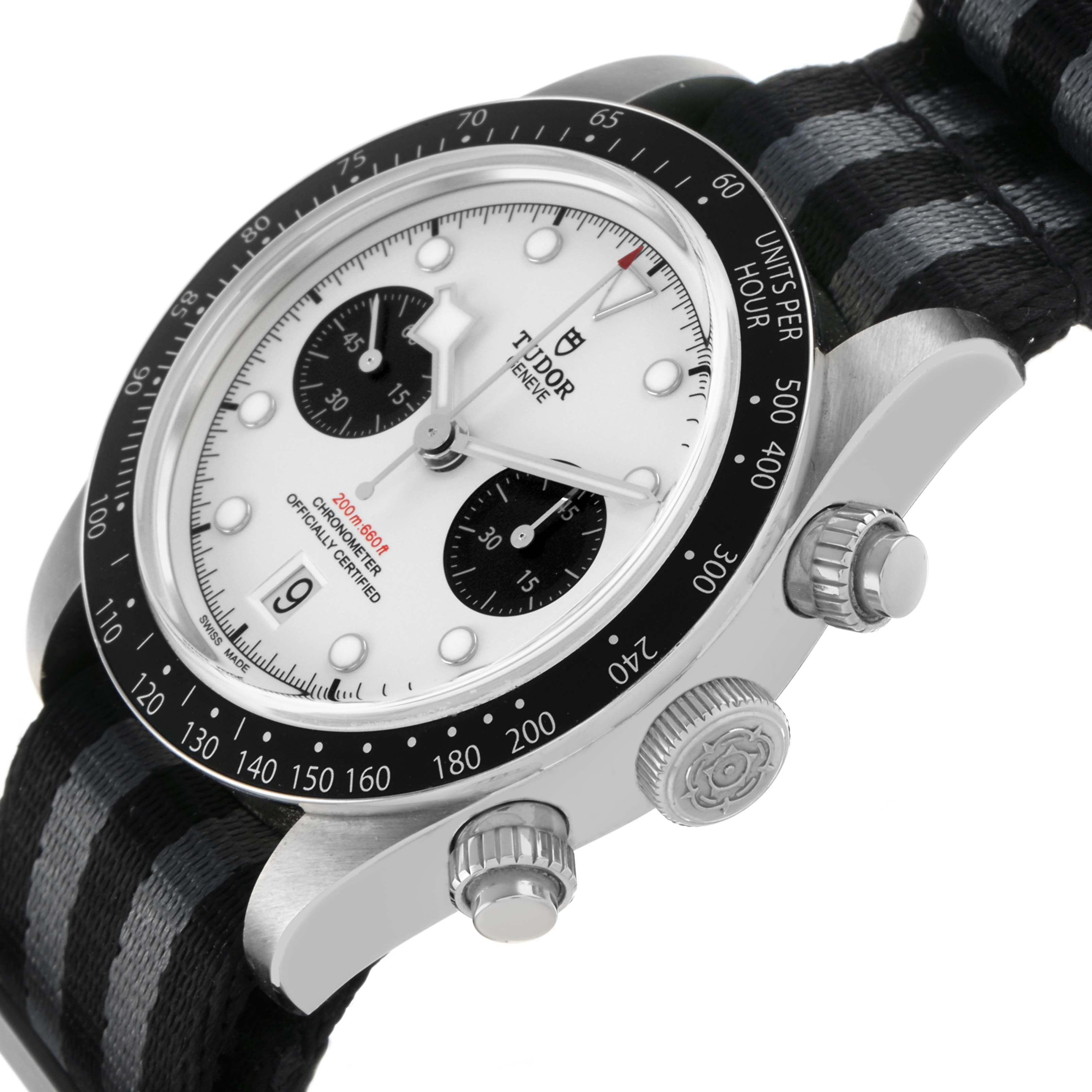 The Tudor Heritage Chrono 79360 Men's Stainless Steel Silver Dial watch is shown at an oblique angle, highlighting its dial, bezel, pushers, crown, and fabric strap.