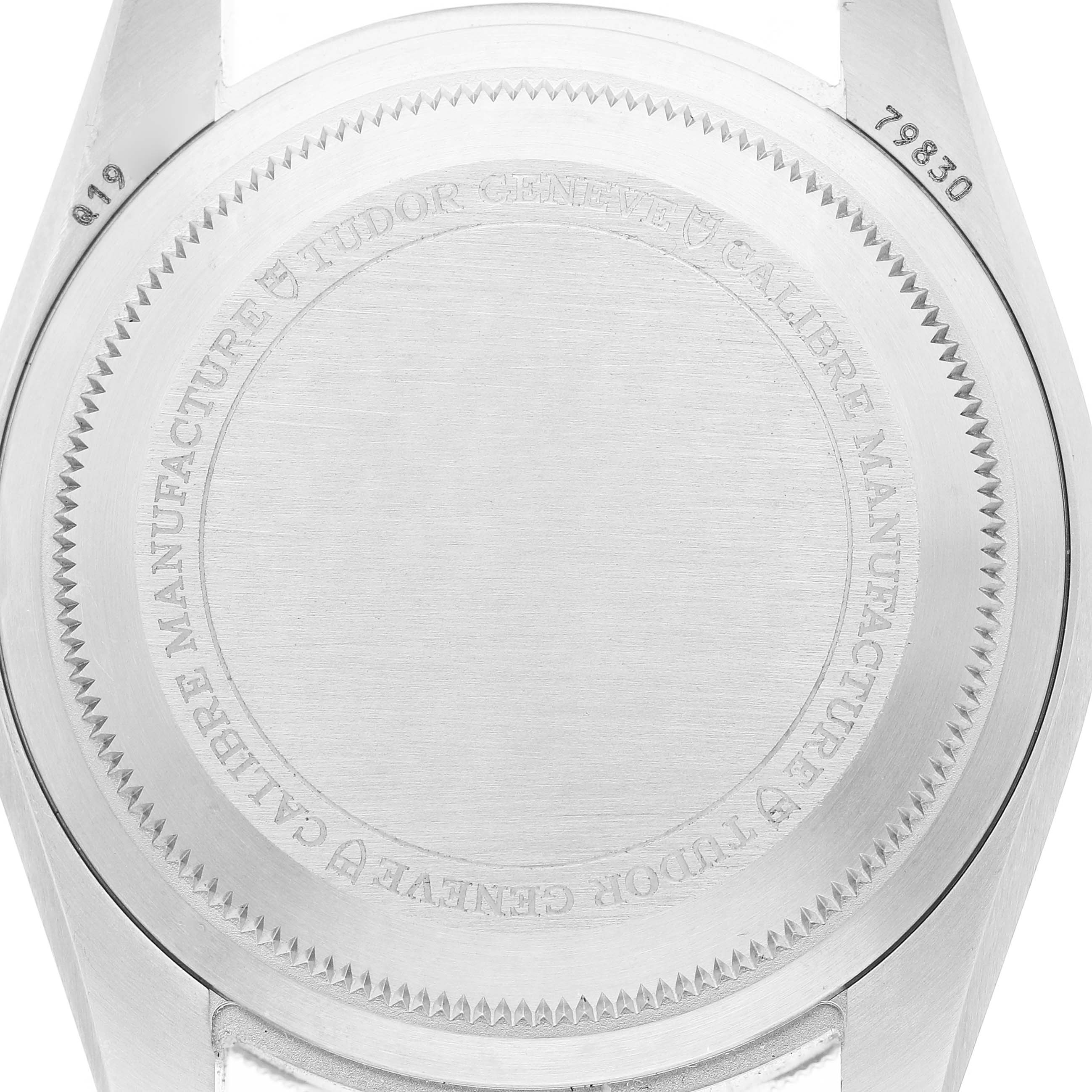 The image shows the back case of a Tudor Heritage Black Bay 79830RB Men's Stainless Steel Black Dial watch, featuring engravings and a brushed finish.