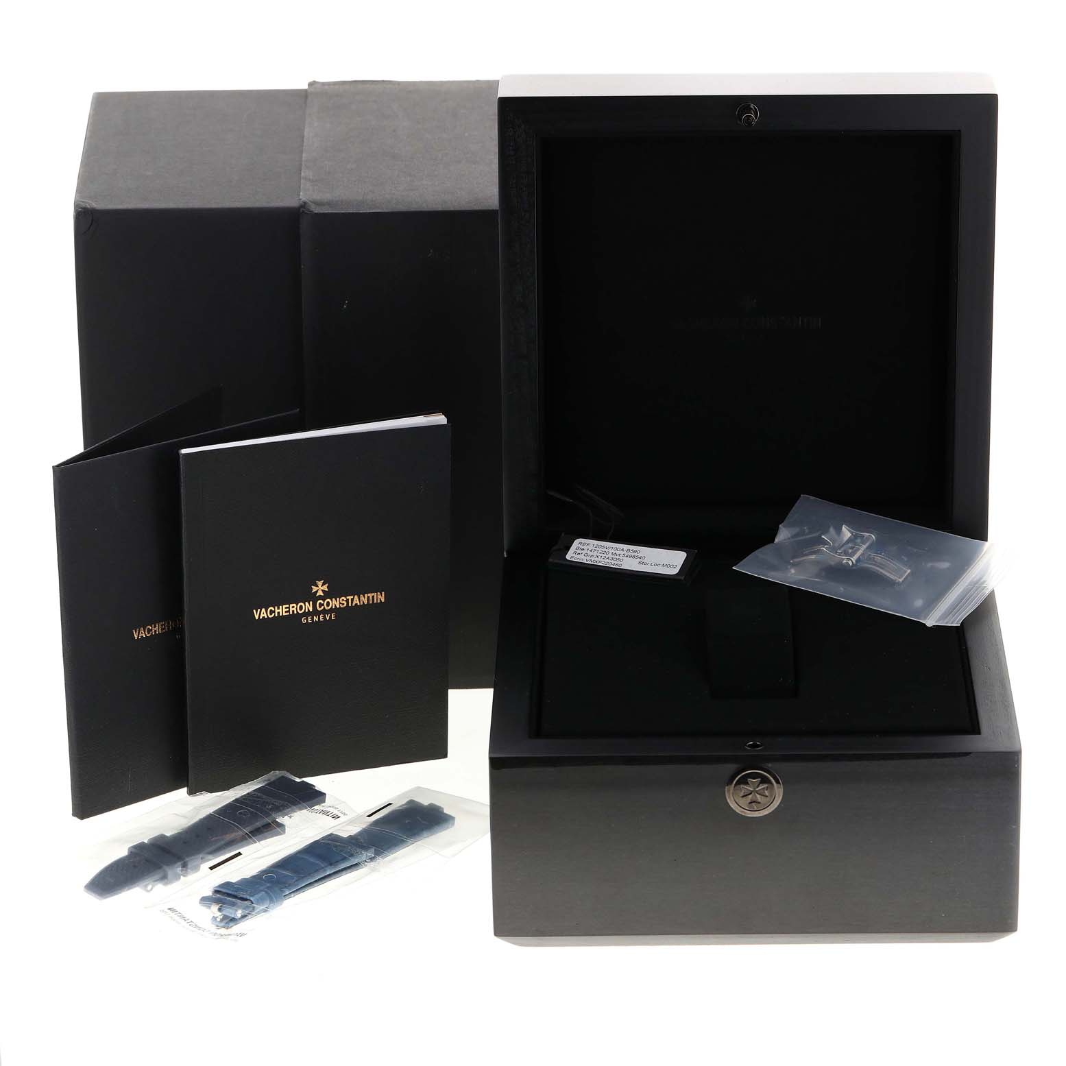 The image shows the packaging, booklets, and additional straps for the Vacheron Constantin Overseas 1205V/100A-B590 Women's Stainless Steel Blue Dial 1205V/100A-B590 Women's Stainless Steel Blue Dial watch, arranged from a front angle.