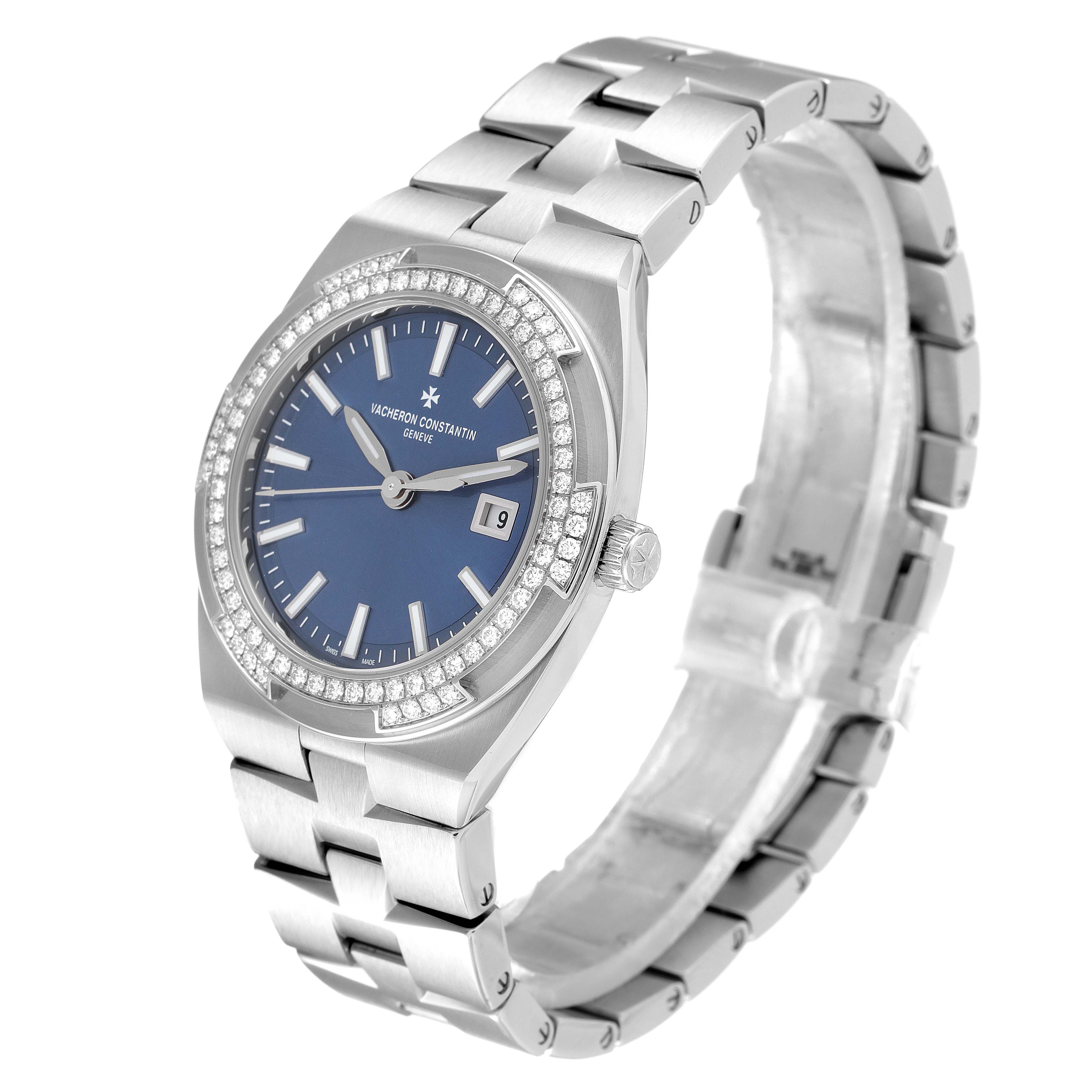 The image shows a side angle view of a Vacheron Constantin Overseas 1205V/100A-B590 Women's Stainless Steel Blue Dial 1205V/100A-B590 Women's Stainless Steel Blue Dial model watch, highlighting its face, bezel, and bracelet.