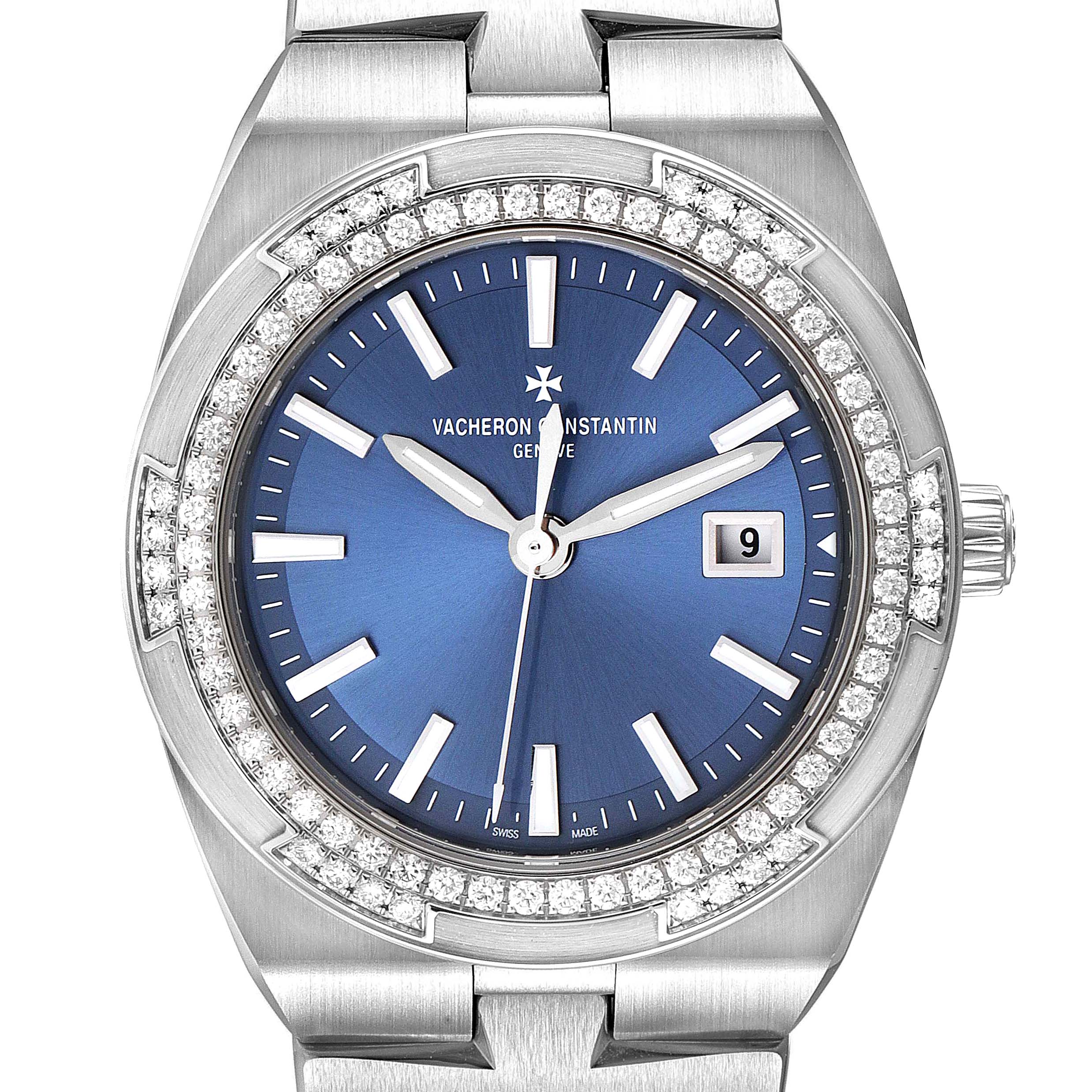 The Vacheron Constantin Overseas 1205V/100A-B590 Women's Stainless Steel Blue Dial 1205V/100A-B590 Women's Stainless Steel Blue Dial watch is shown from a front angle, featuring a blue dial, diamond-set bezel, and metal bracelet.