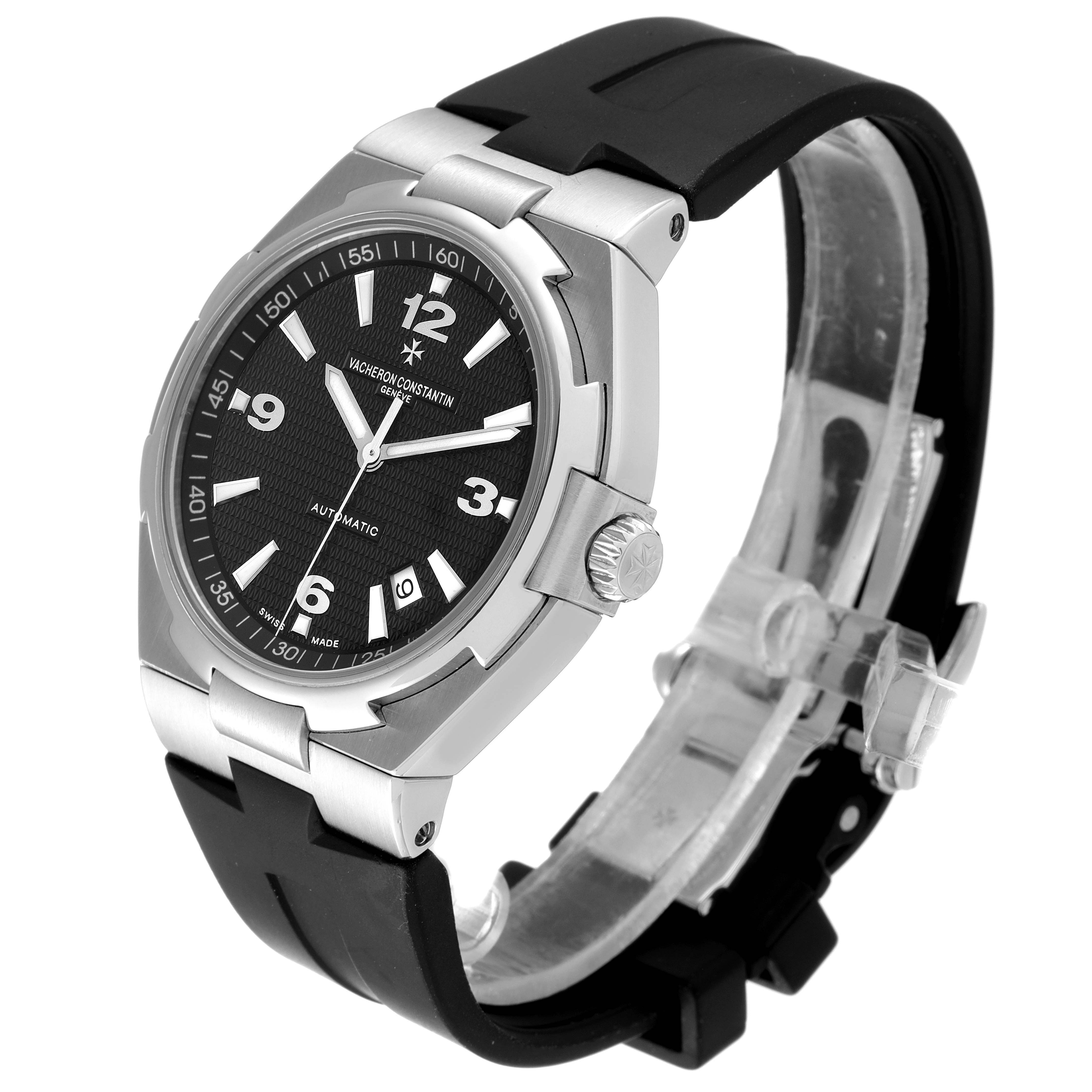 The image shows a Vacheron Constantin Overseas 47040/B01A-9094 Men's Stainless Steel Black Dial 47040/B01A-9094 Men's Stainless Steel Black Dial watch from an angled perspective, highlighting the face, crown, and black rubber strap.