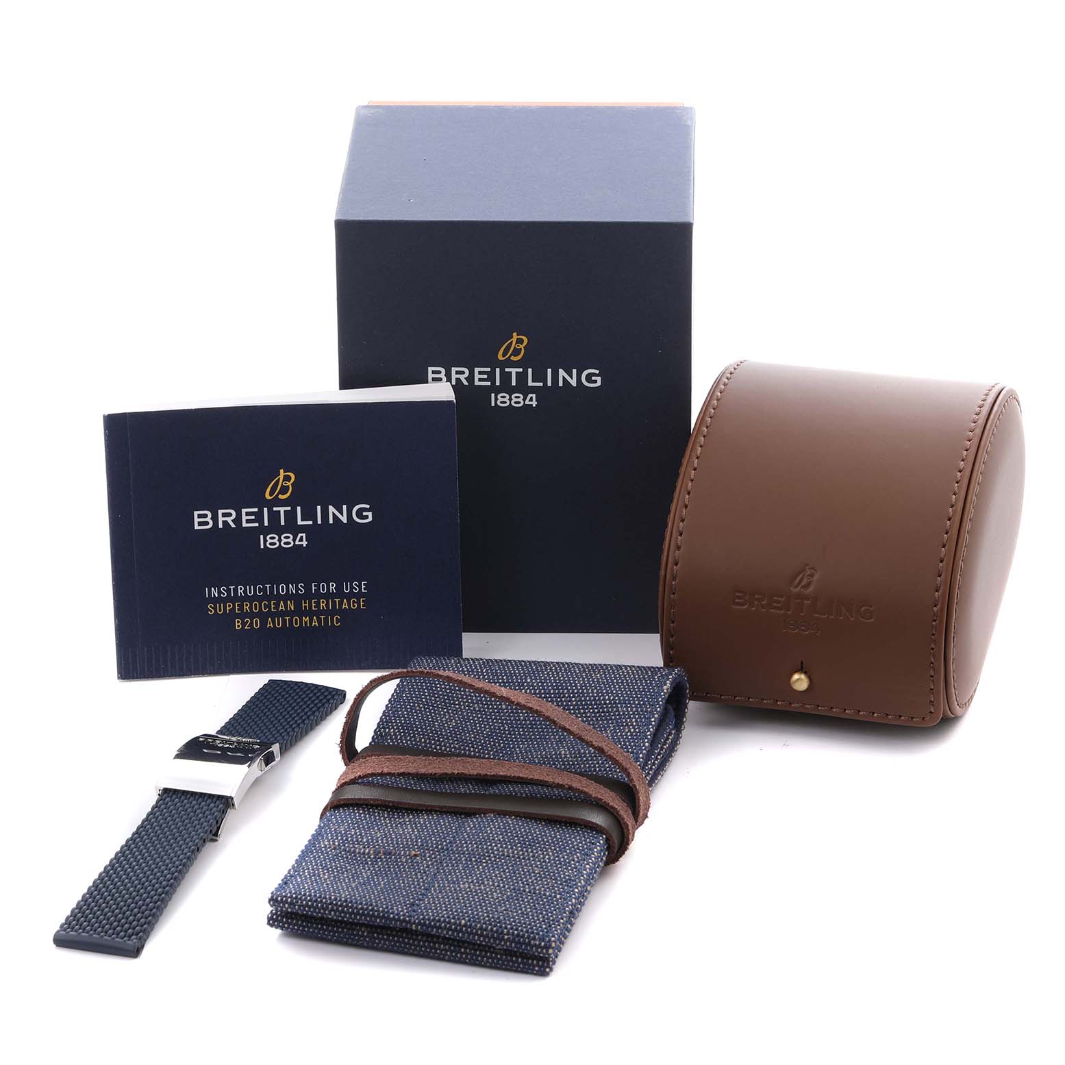 The image shows accessories for a Breitling Superocean AB2020161C1A1 Men's Stainless Steel Blue Dial AB2020161C1A1 Men's Stainless Steel Blue Dial, including a strap, watch box, manual, and travel case, from a frontal angle.