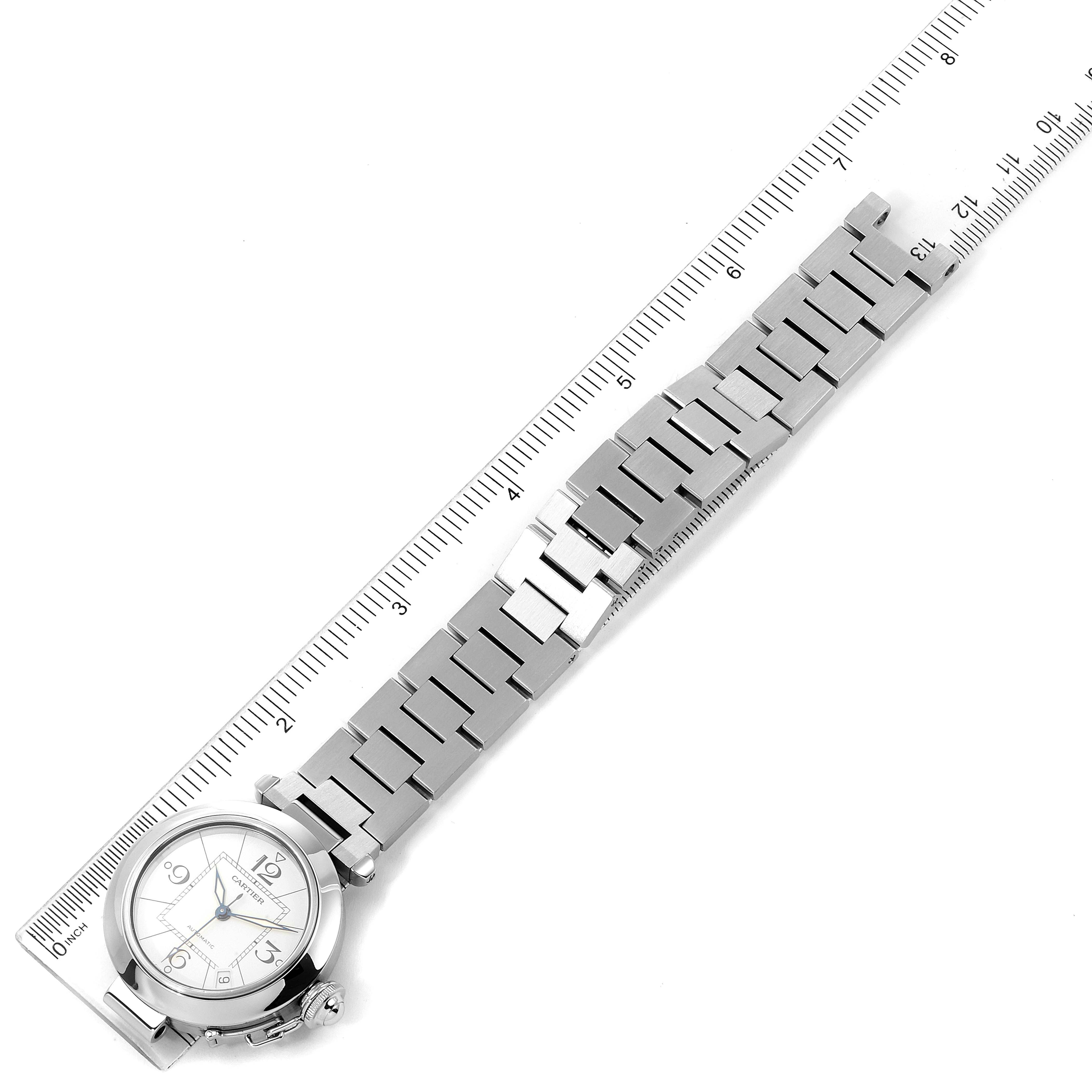 This image shows a Cartier Pasha W31074M7 Men's Stainless Steel White Dial W31074M7 Men's Stainless Steel White Dial watch with a full view of the face and stainless steel bracelet, placed alongside a ruler.