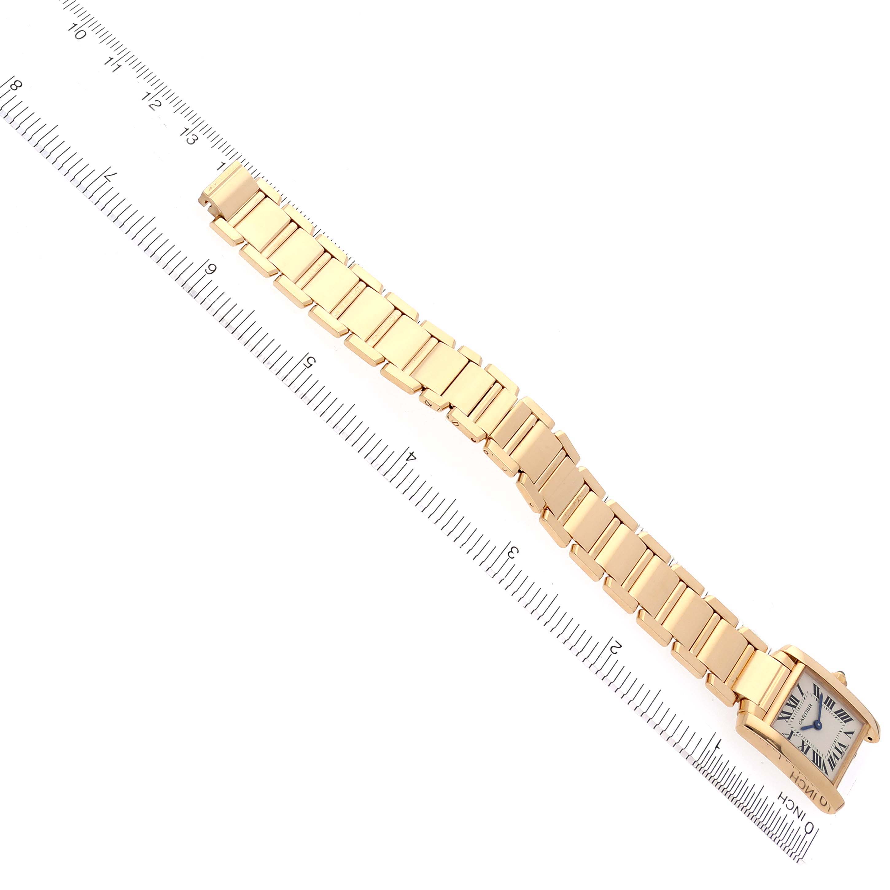 The Cartier Tank Francaise W50002N2 Women's Yellow Gold Silver Dial W50002N2 Women's Yellow Gold Silver Dial watch is shown flat, displaying the face and entire gold bracelet against a measuring ruler.
