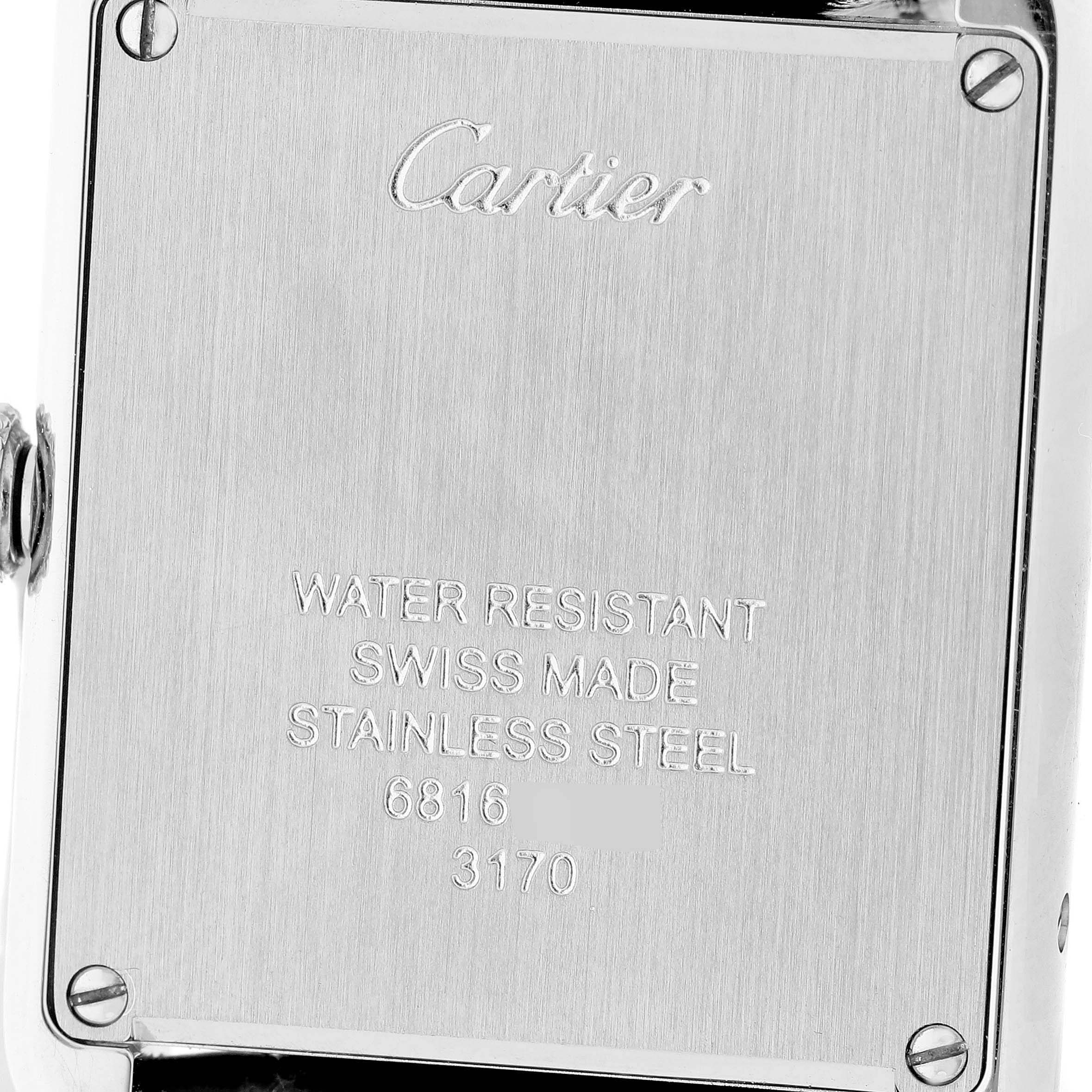 The image shows the back case of a Cartier Tank Solo WSTA0030 Women's Stainless Steel Silver Dial watch, highlighting engravings and screws.