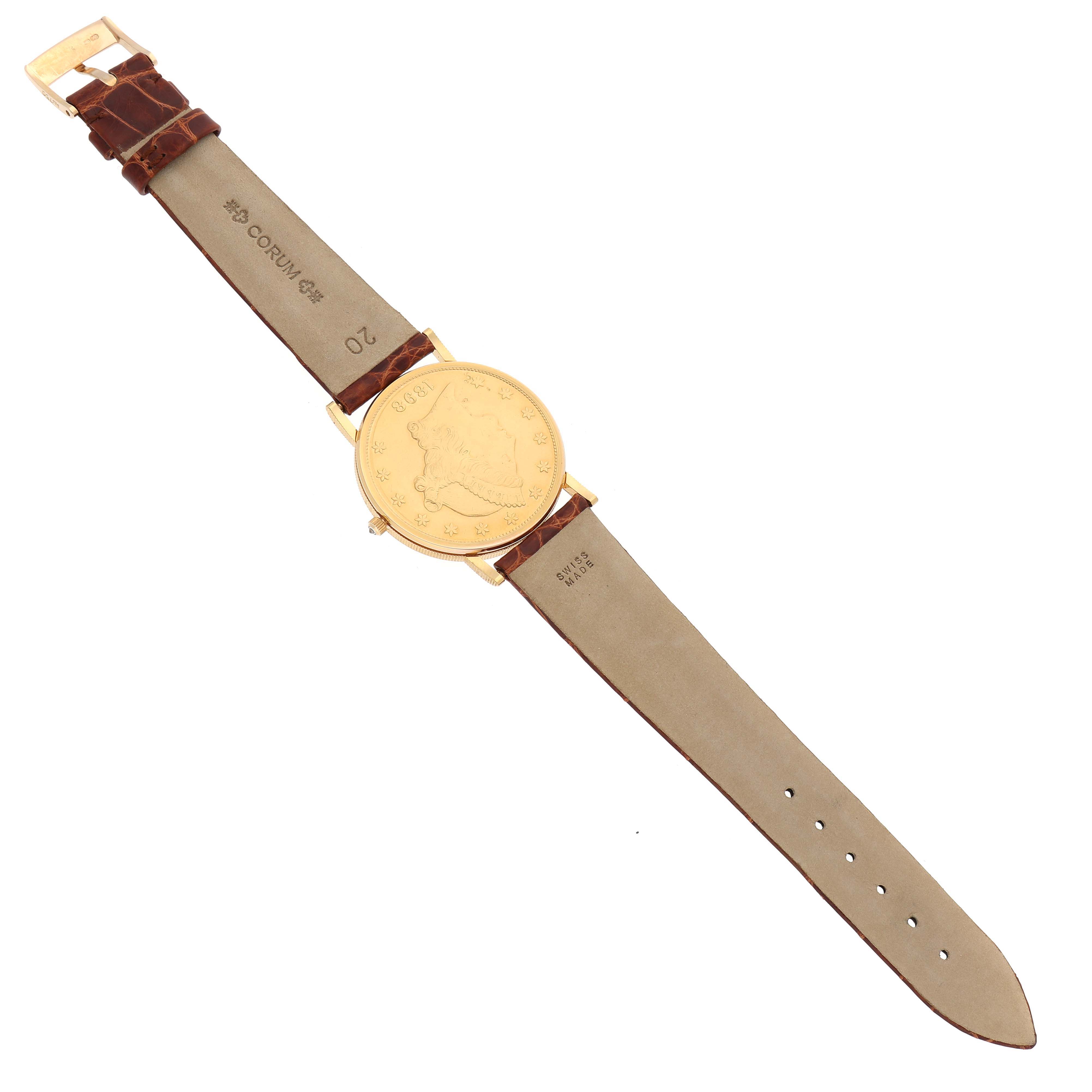The Coin Watch model by Corum is shown from a top-down angle, displaying its gold face and brown leather strap.