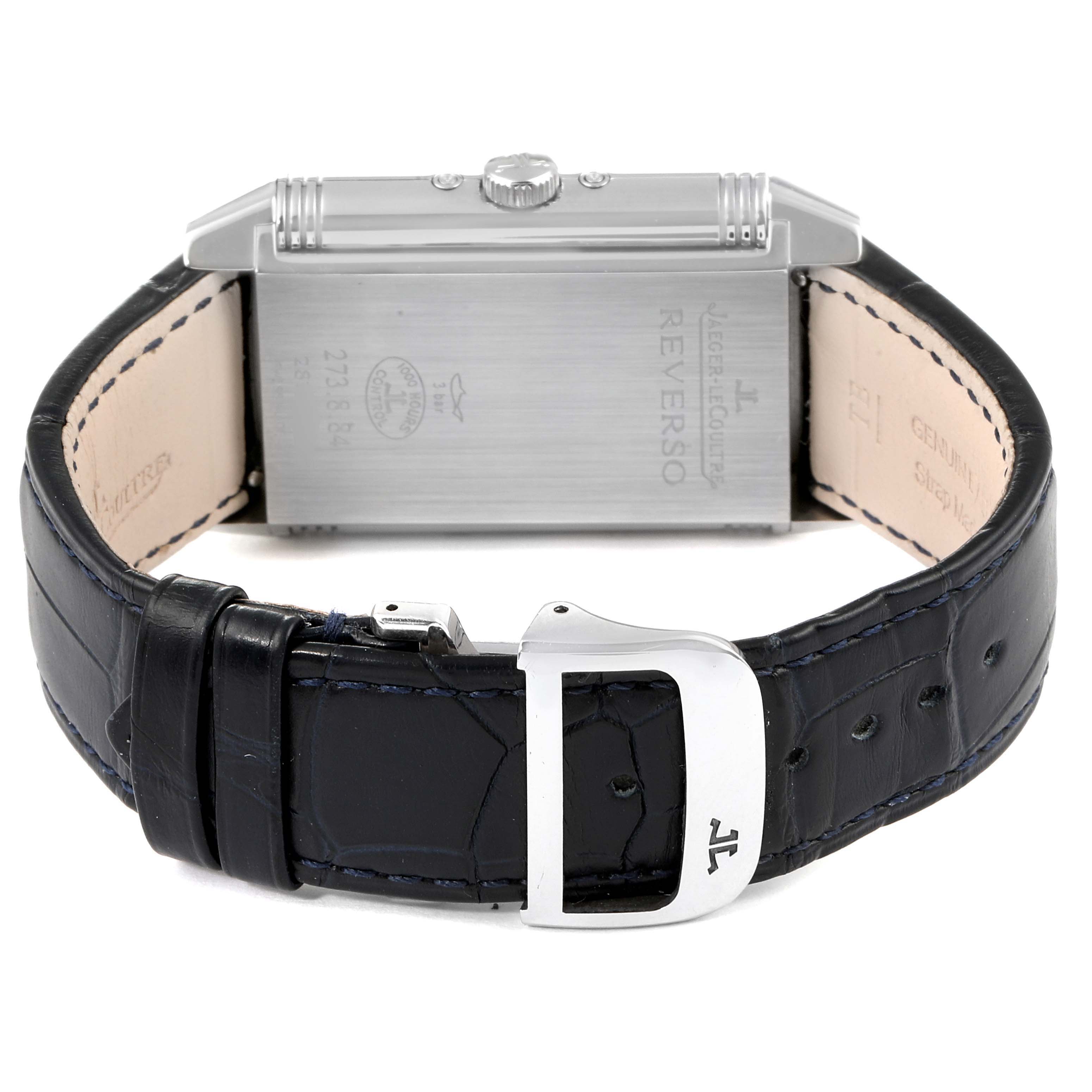 This image shows the back of a Jaeger-LeCoultre Reverso watch, including the case back, crown, and leather strap with buckle.