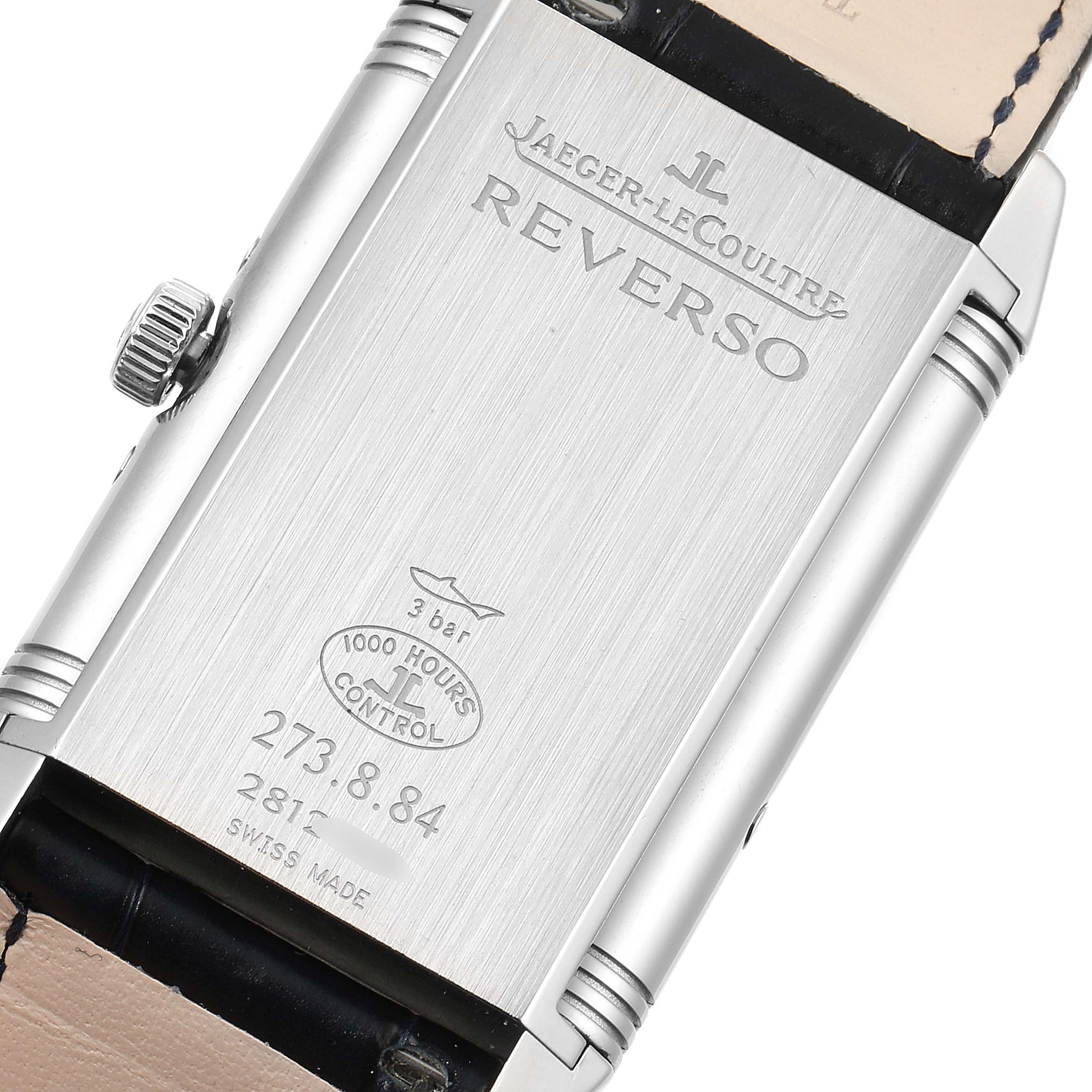 The image shows the back case of a Jaeger-LeCoultre Reverso watch, displaying brand inscriptions and model details.