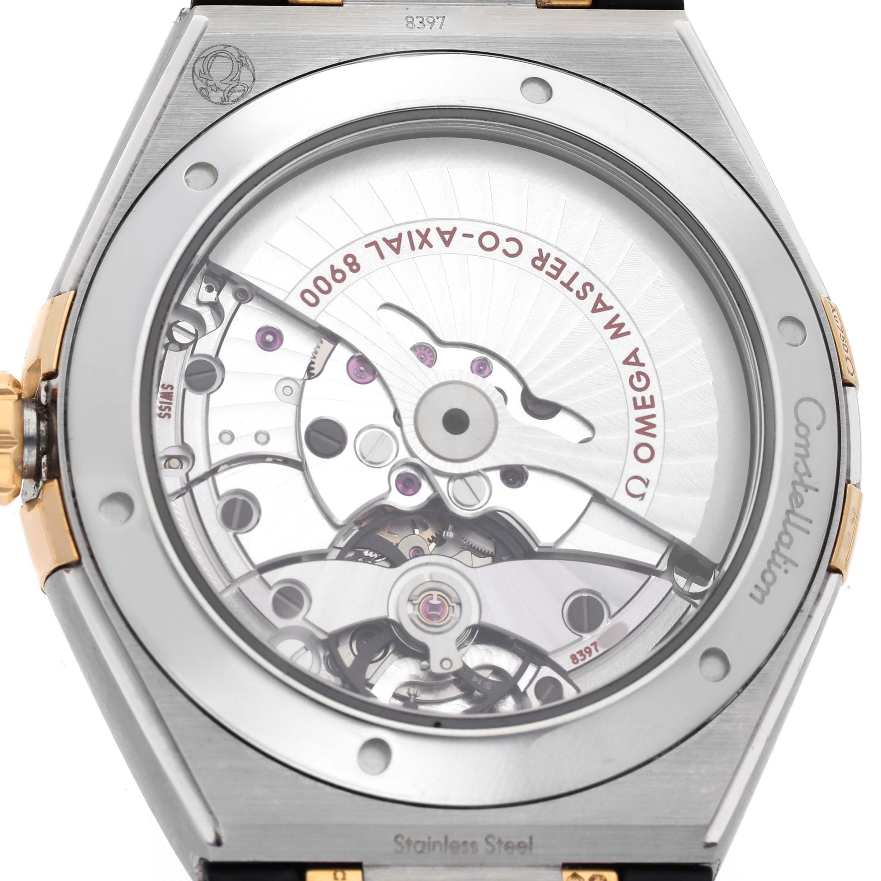 The image shows the back view of the Omega Constellation 131.23.41.21.10.001 Men's Steel and Gold (two tone) Green Dial watch, highlighting the exposed movement and rotor inside.