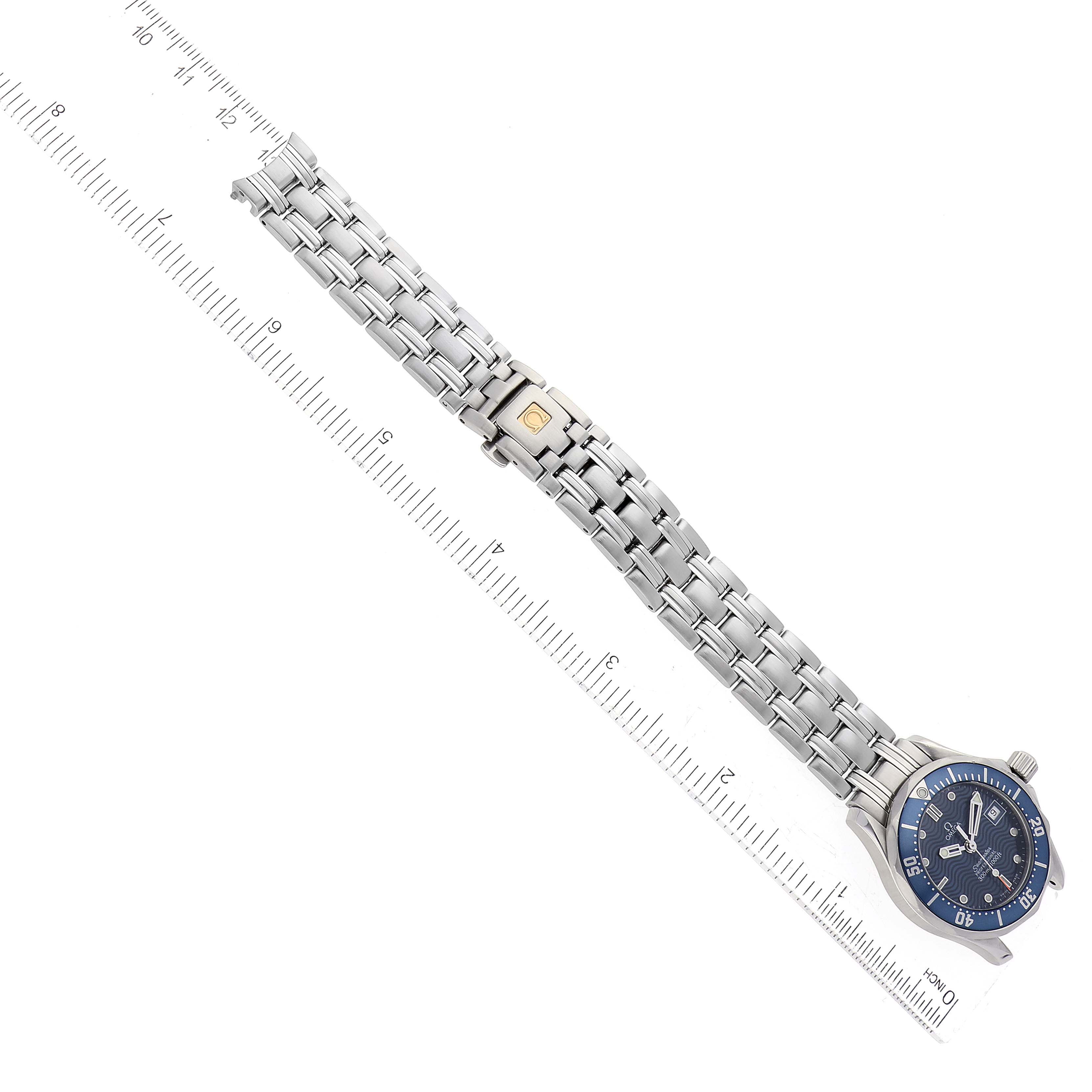 The Omega 2583.80.00 Women's Stainless Steel Blue Dial 2583.80.00 Women's Stainless Steel Blue Dial Seamaster Diver 300M 28mm Steel Ladies Watch 2583.80.00 is shown from above, fully extended with a ruler for size reference.