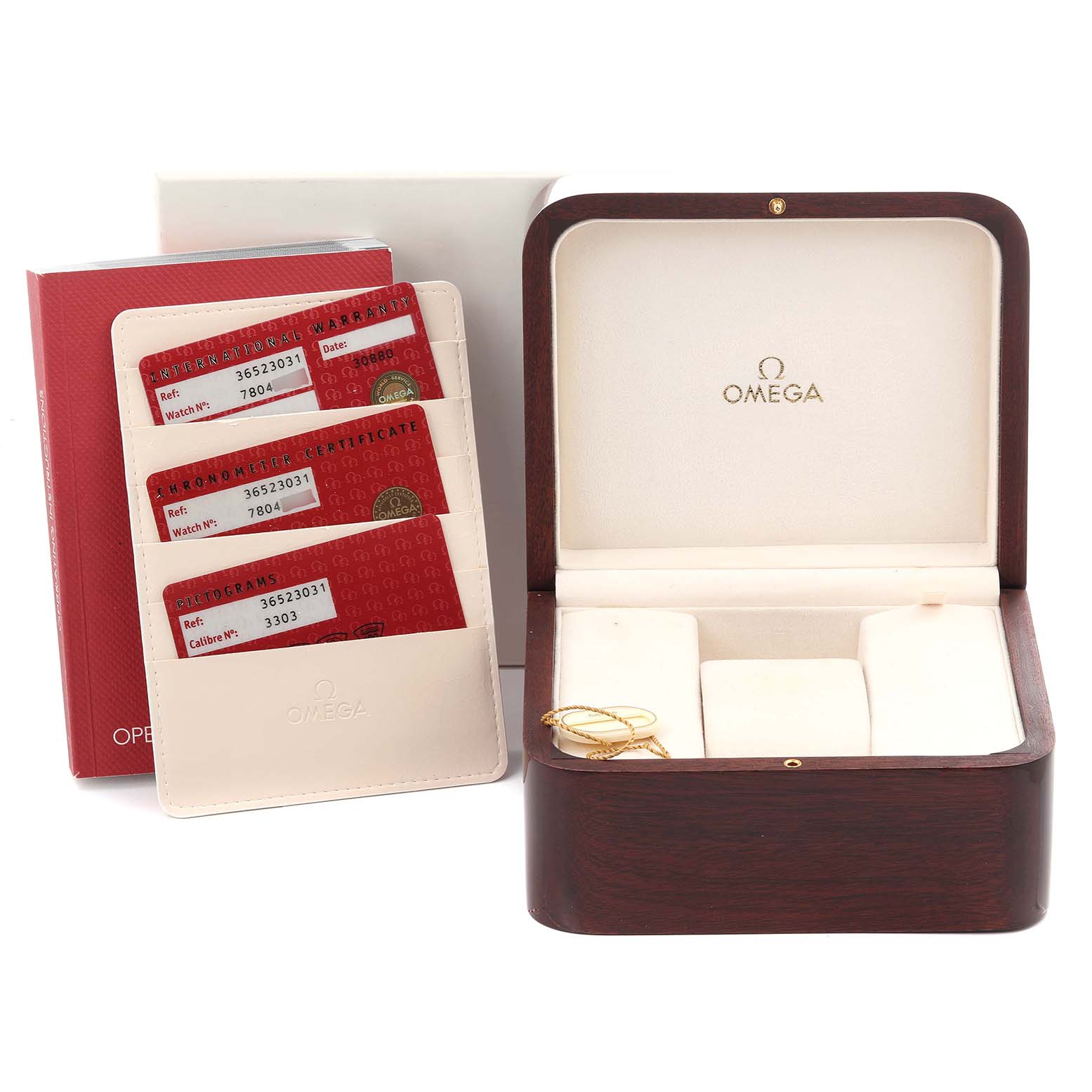 The image shows an Omega Speedmaster 3652.30.31 Men's White Gold Silver Dial 3652.30.31 Men's White Gold Silver Dial watch box, cards, and accessories displayed from the front.