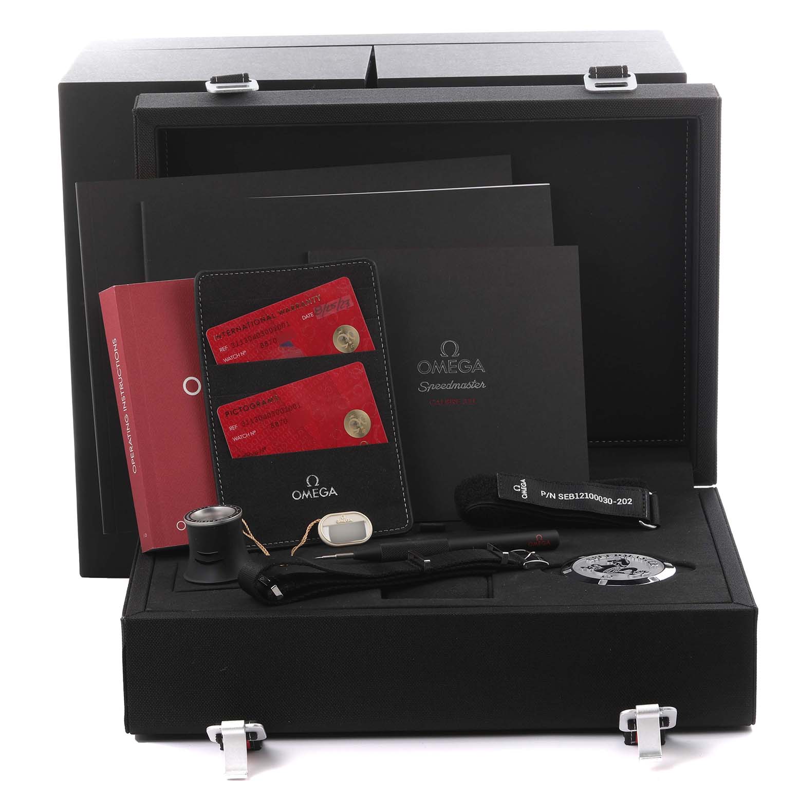 The Omega Speedmaster 311.30.40.30.01.001 Men's Stainless Steel Black Dial 311.30.40.30.01.001 Men's Stainless Steel Black Dial set is shown from the front, featuring the box, paperwork, strap, loupe, and medallion accessories.