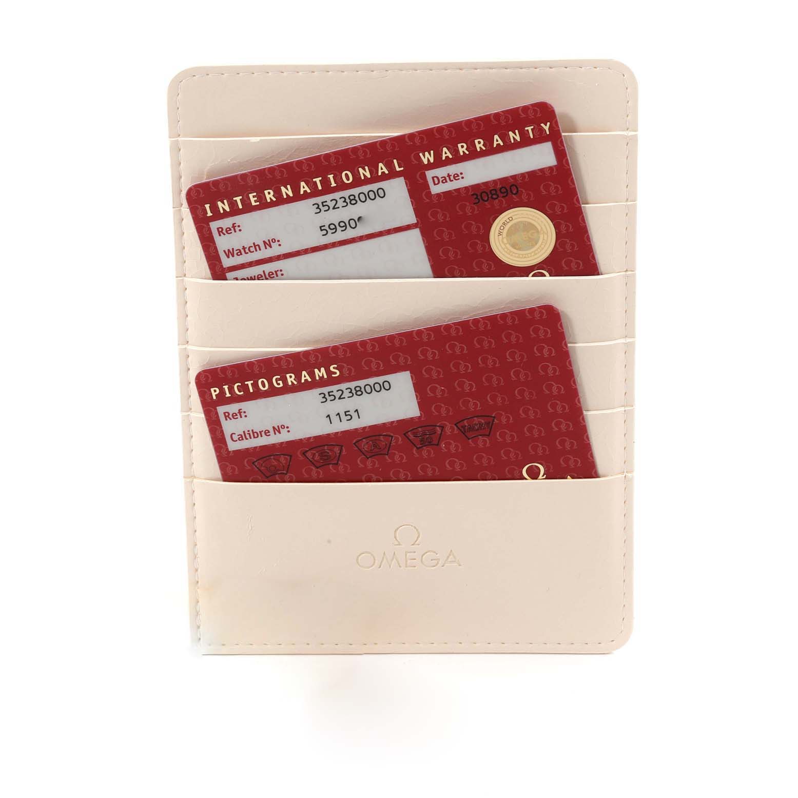 The image shows an Omega cardholder with International Warranty and Pictograms cards for the Speedmaster model.