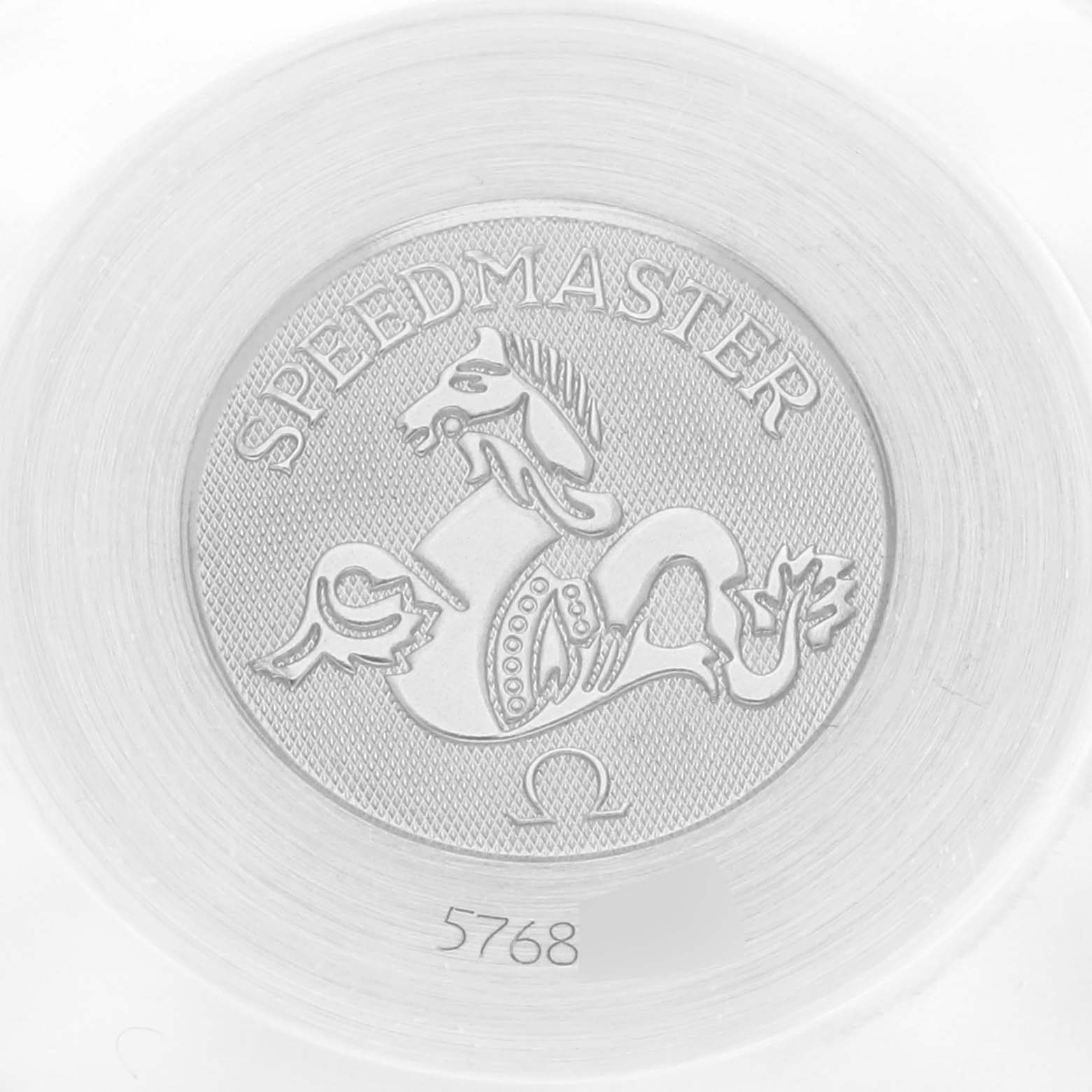 The image shows a close-up of the Omega Speedmaster 3510.21.00 Men
s Stainless Steel White Dial 3510.21.00 Men
s Stainless Steel White Dial
s emblem, featuring a horse design with the brand logo and model name engraved.