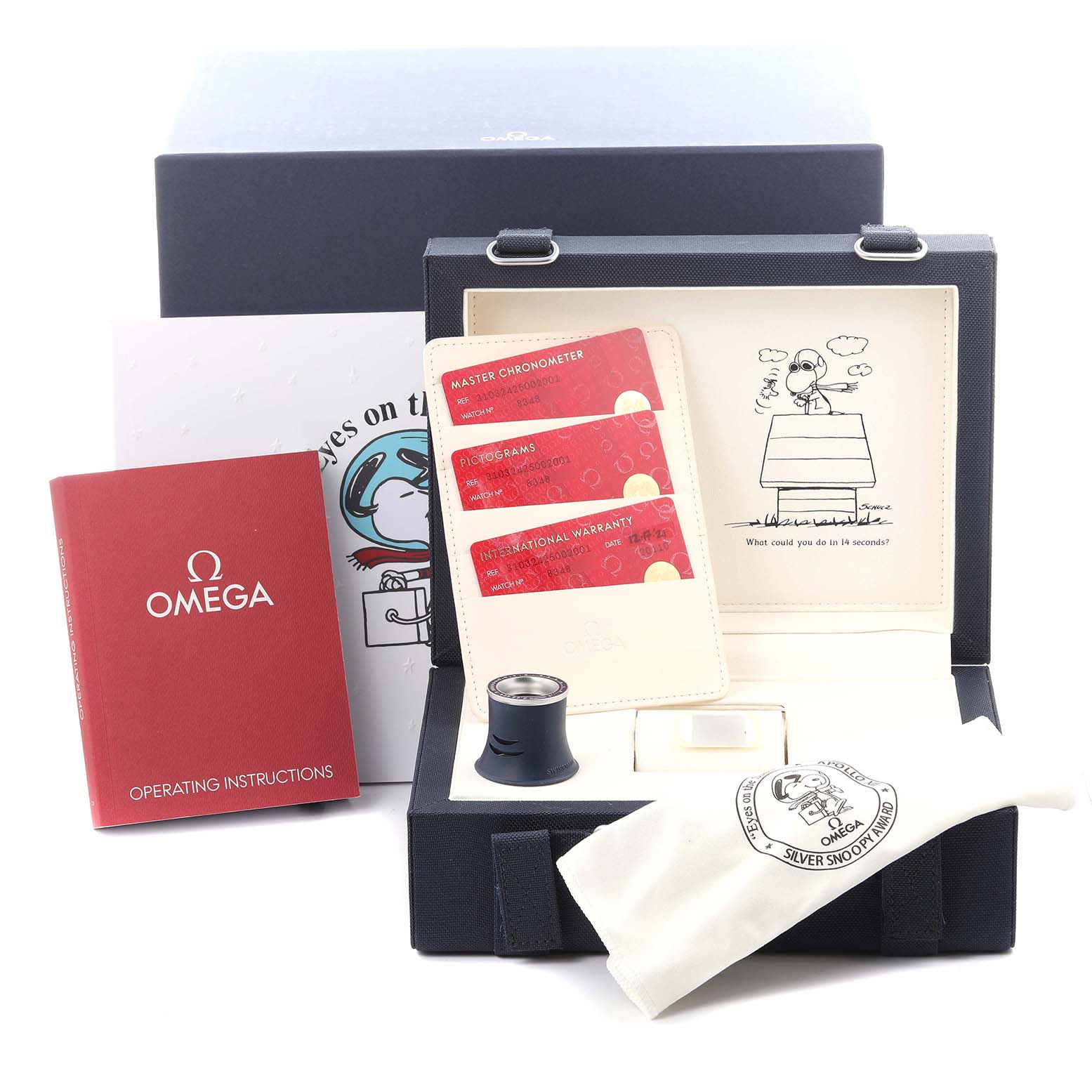 The image shows accessories for an Omega Speedmaster 310.32.42.50.02.001 Men's Stainless Steel Silver Dial 310.32.42.50.02.001 Men's Stainless Steel Silver Dial, including a box, manual, cards, loupe, and pouch at a frontal angle.