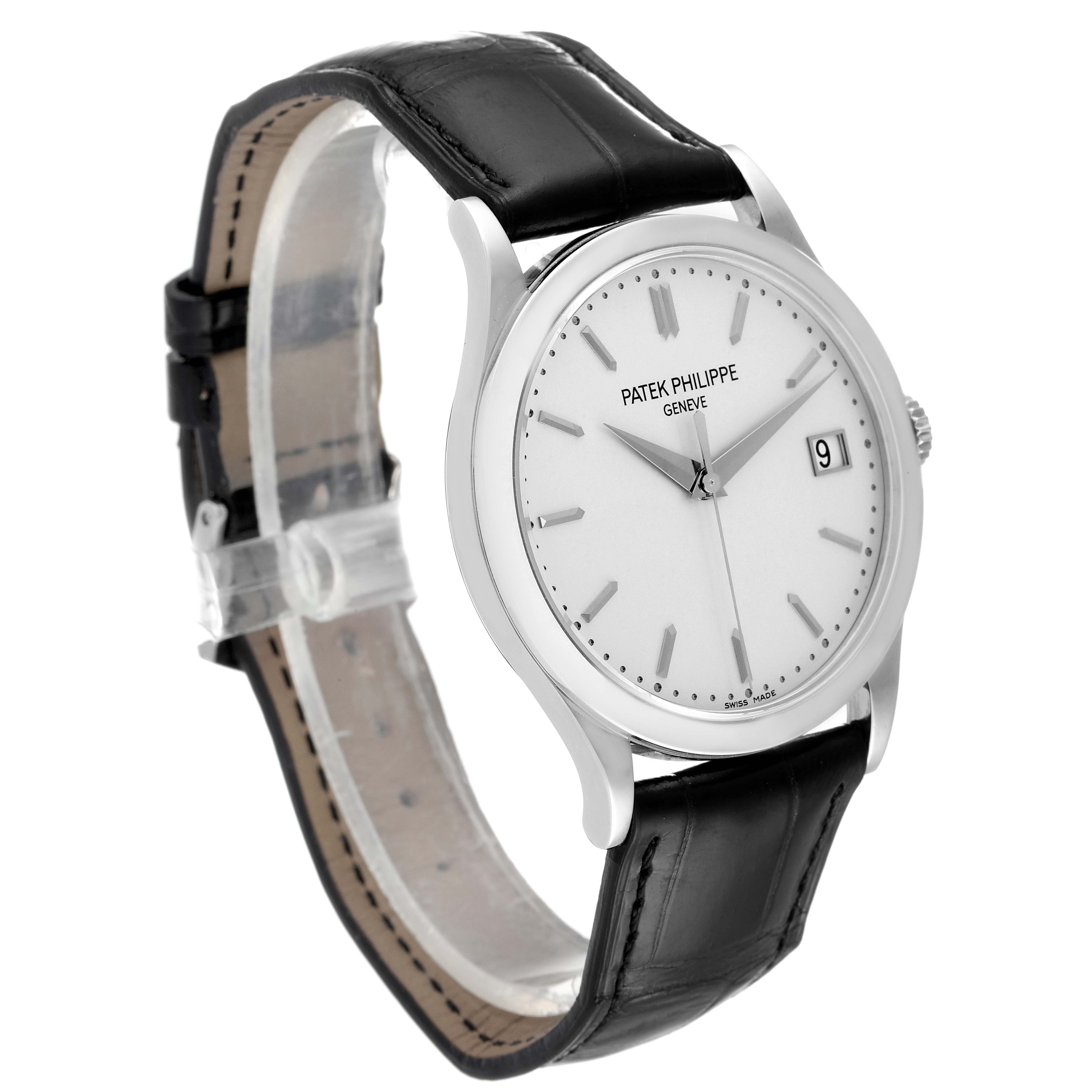 The image shows a side view of the Patek Philippe Calatrava 5296G Men's White Gold Silver Dial 5296G Men's White Gold Silver Dial watch with a black leather strap and a white dial displaying the date.
