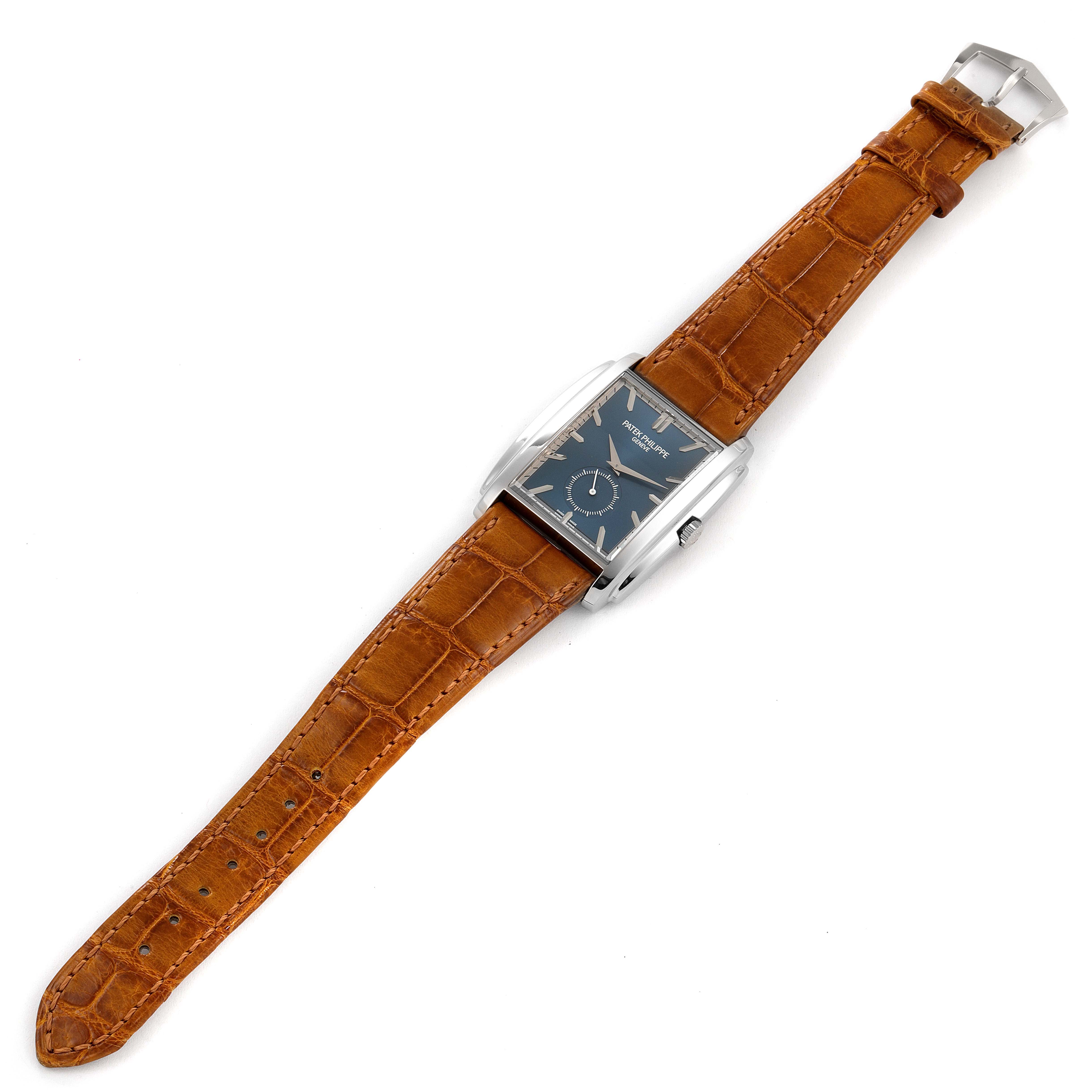 The image shows a Patek Philippe Gondolo 5124G Men's White Gold Blue Dial 5124G Men's White Gold Blue Dial watch from a top-down angle, featuring the watch face, brown leather strap, and buckle.