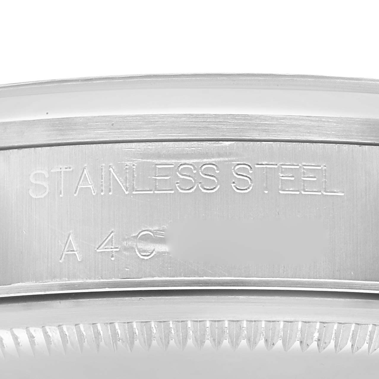 The image shows a close-up of the stainless steel case back's edge of a Rolex Air-King 14000 Men's Stainless Steel Black Dial 14000 Men's Stainless Steel Black Dial watch, highlighting engraved lettering.