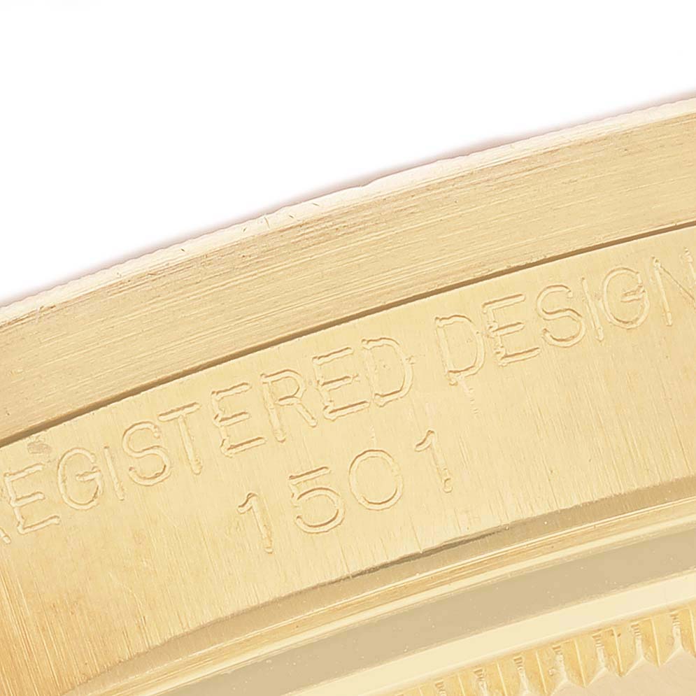 The image shows a close-up of the engraved side of a Rolex Date 1501 Men's Yellow Gold Silver Dial model, highlighting its design number.
