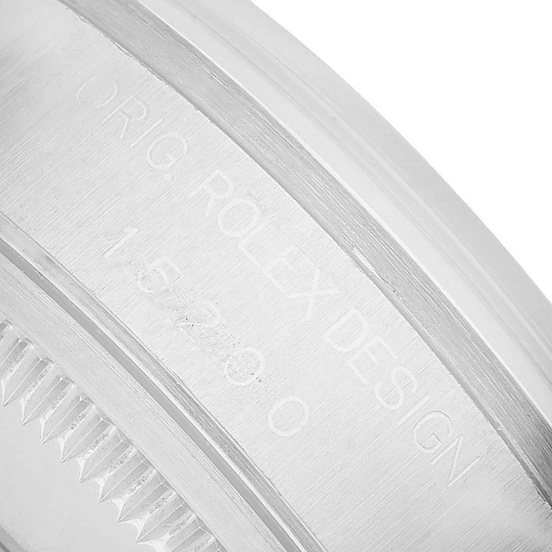The image shows a close-up of the side of a Rolex Date 15200 Men's Stainless Steel White Dial model, focusing on the engraved serial number.