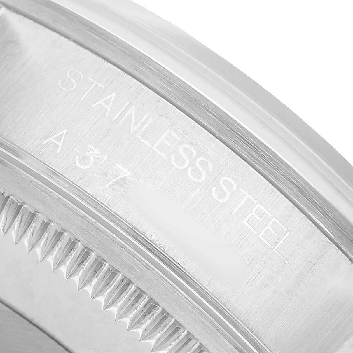The image shows a close-up of the edge and engraving on a stainless steel Rolex Date 15200 Men's Stainless Steel White Dial model watch case.